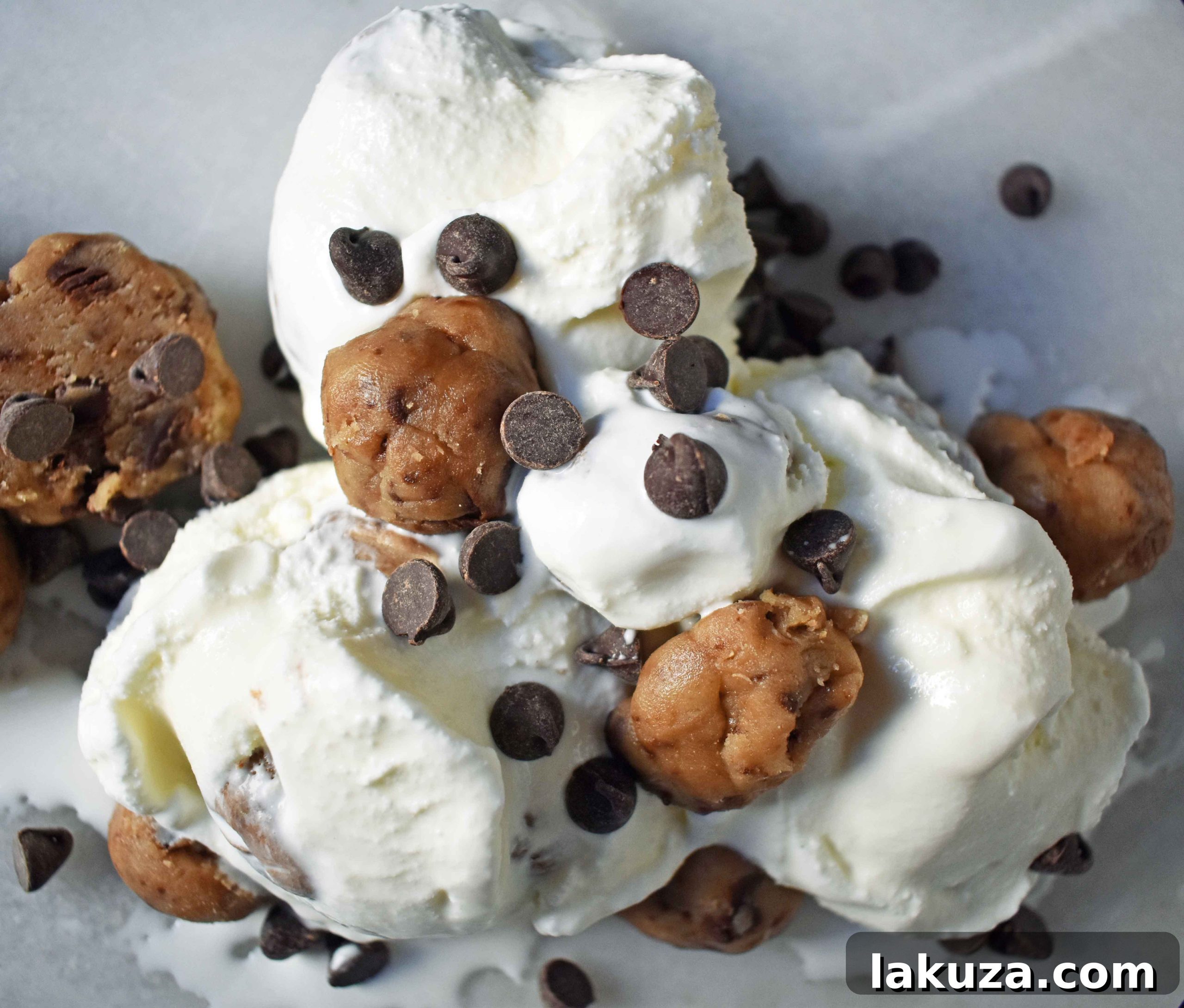 A scoop of homemade chocolate chip cookie dough ice cream in a white bowl.