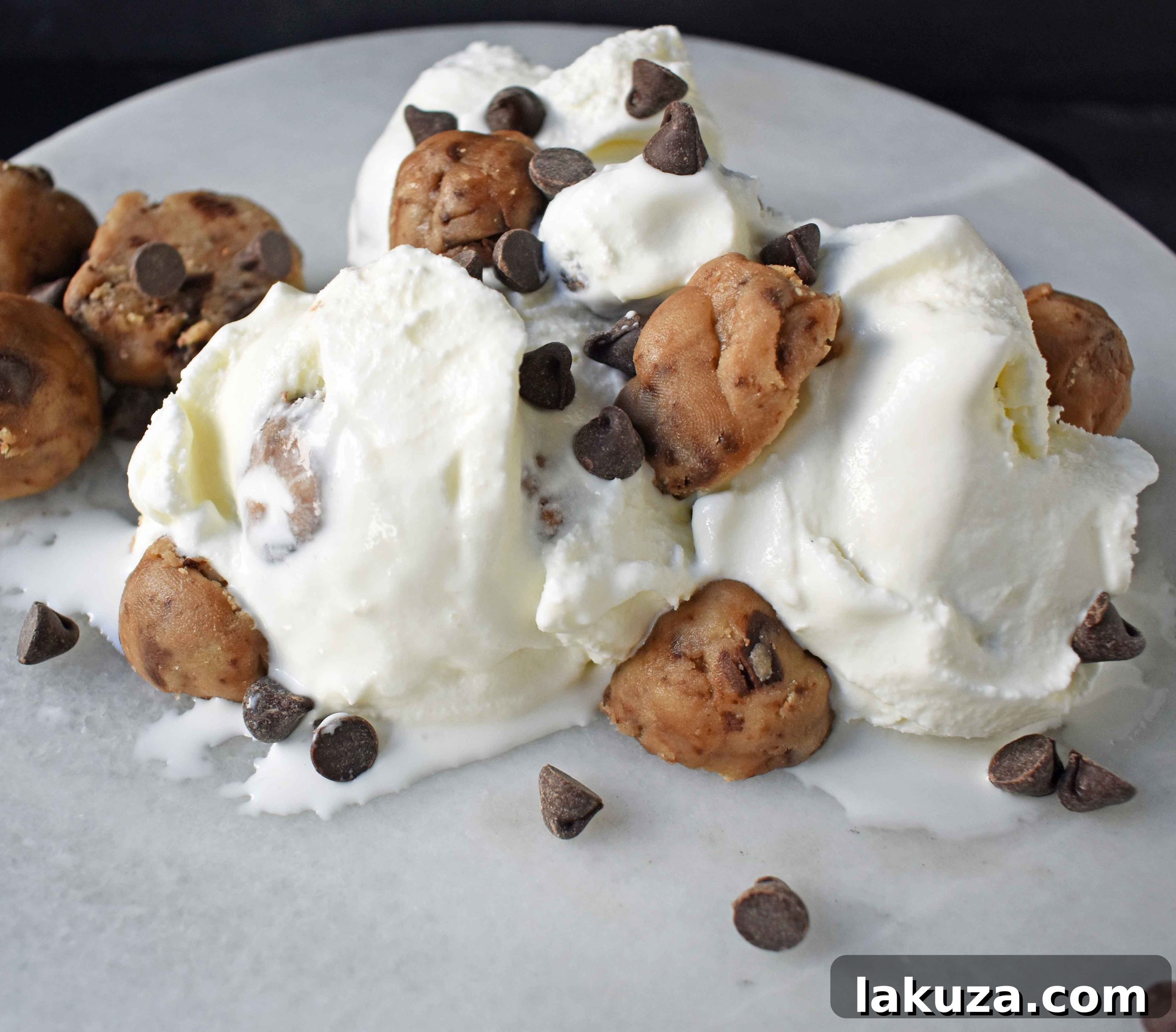 Chunks of edible chocolate chip cookie dough prepared for mixing into ice cream.