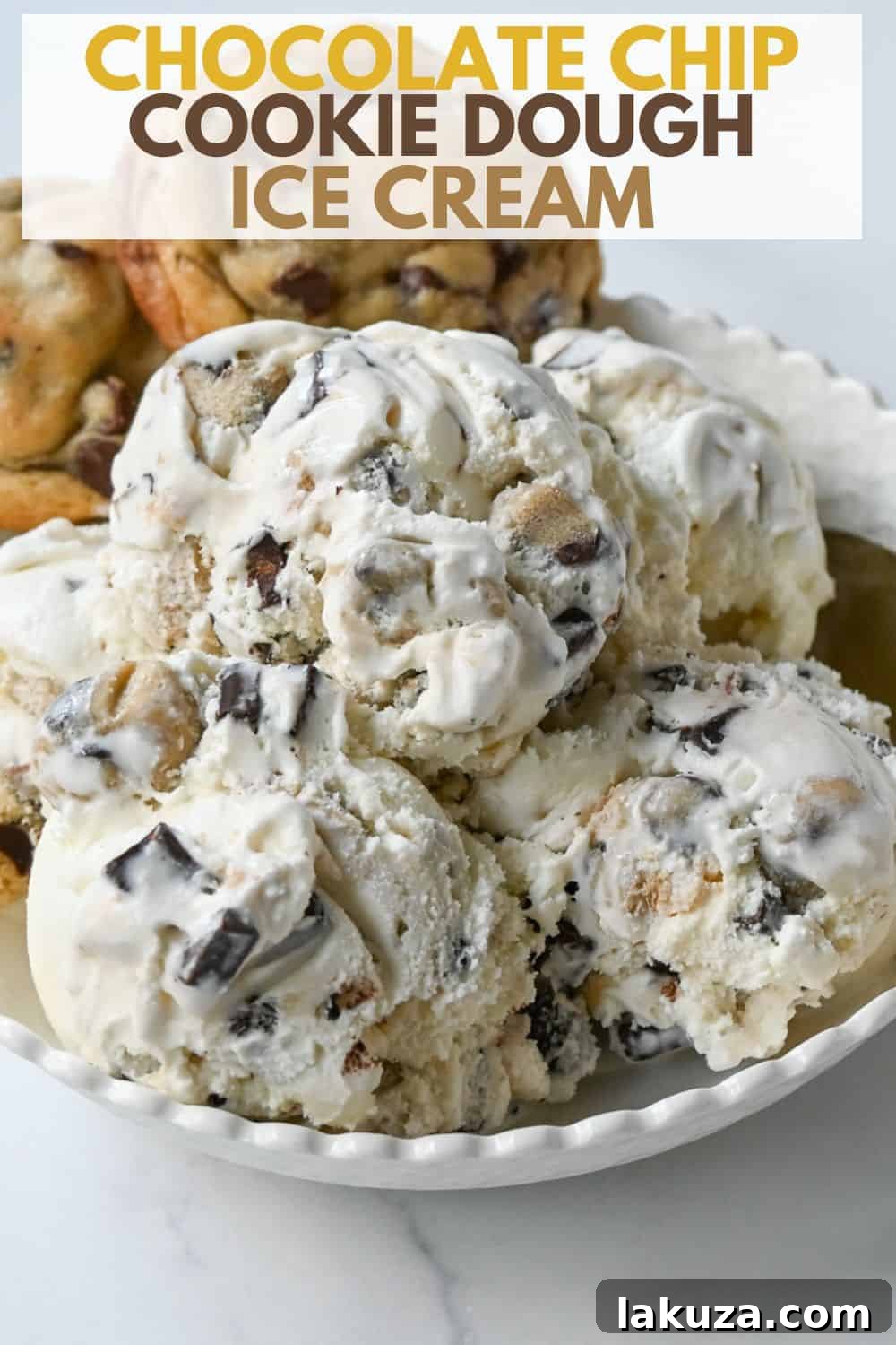 A hand scooping creamy chocolate chip cookie dough ice cream from a container into a cone.