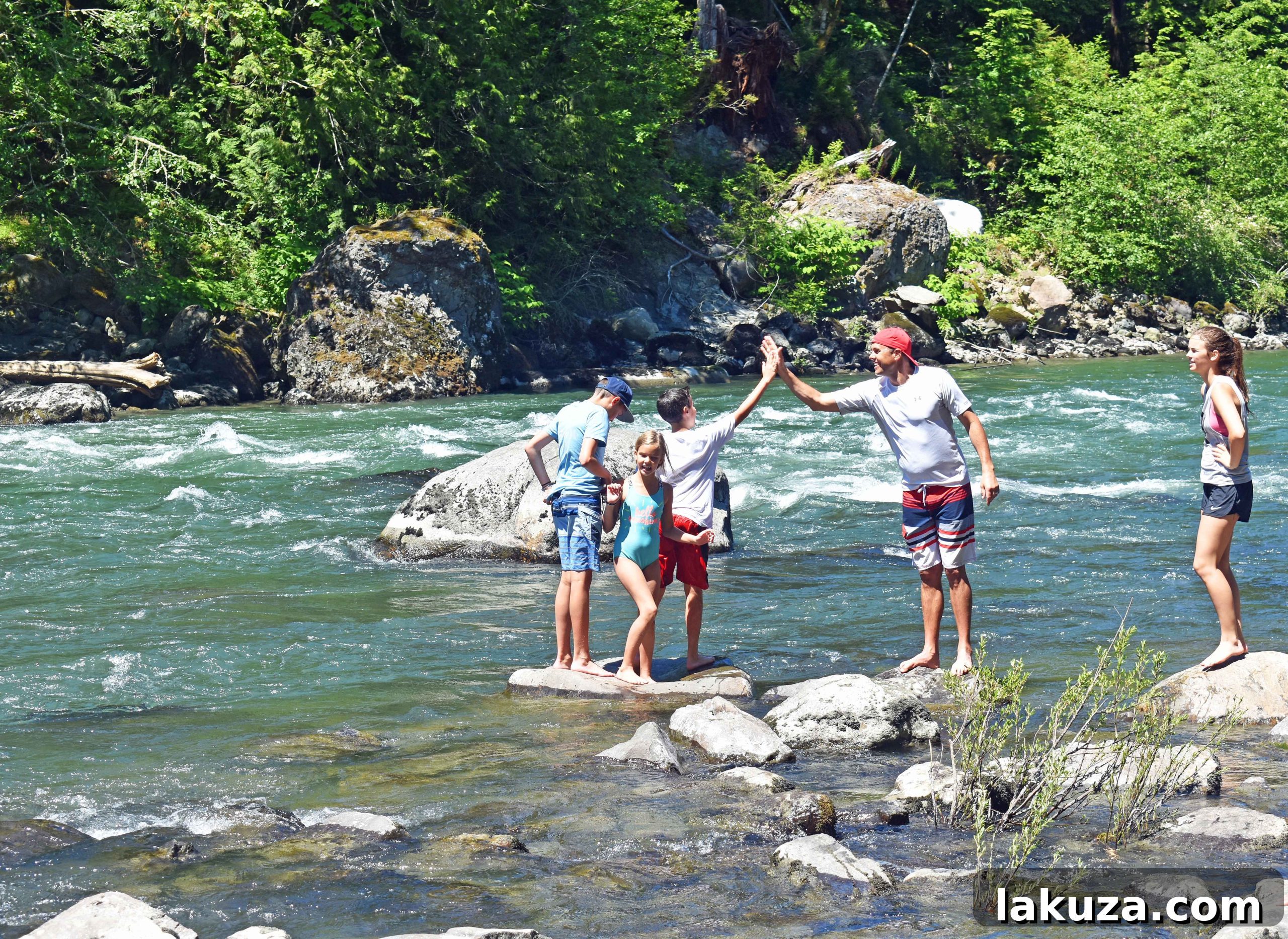 Family enjoying the water near Snoqualmie Falls. An adventurous activity among the best places to see in Seattle.