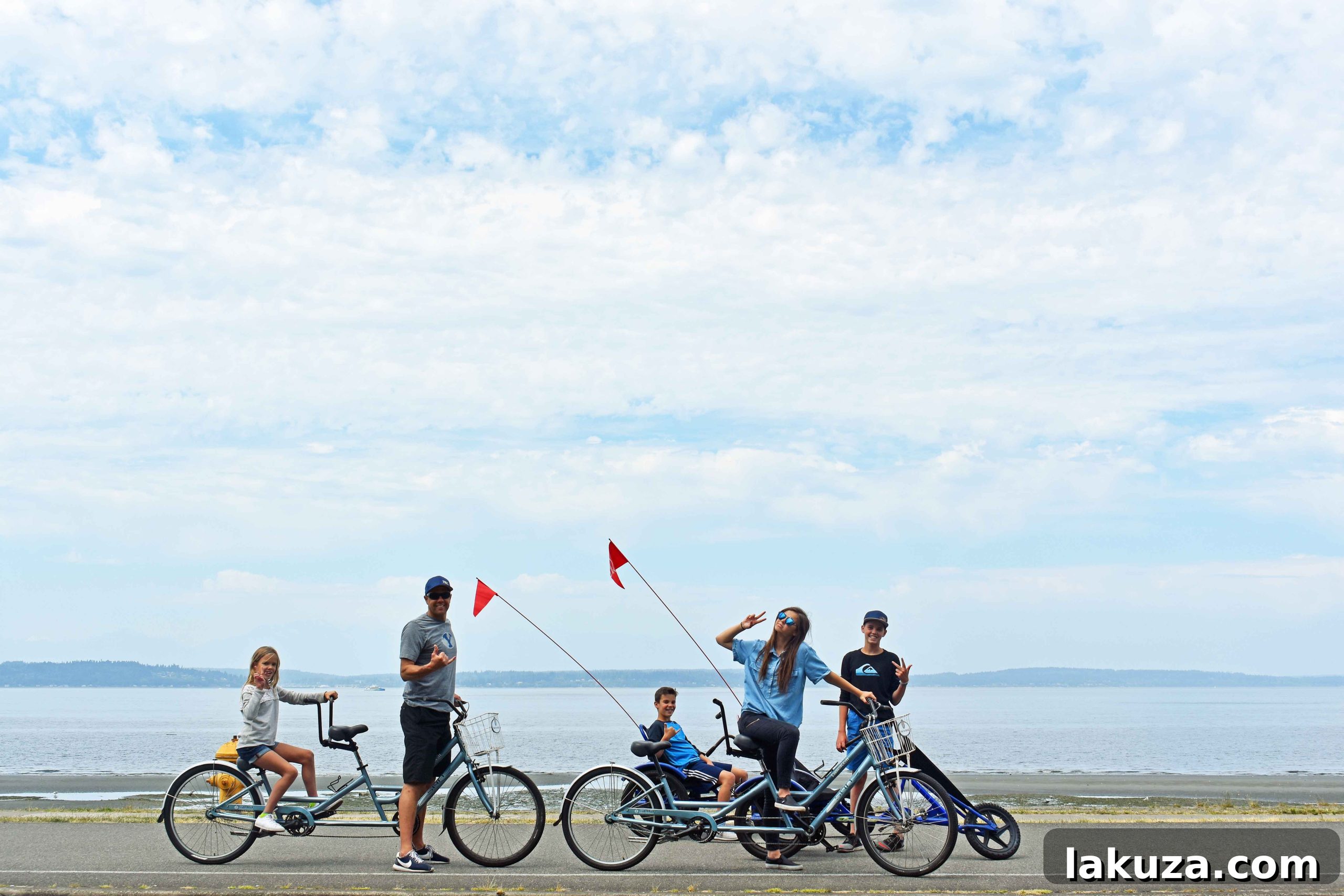 Riding bikes along the boardwalk at Alki Beach, offering scenic city views. A fun outdoor activity in Seattle.