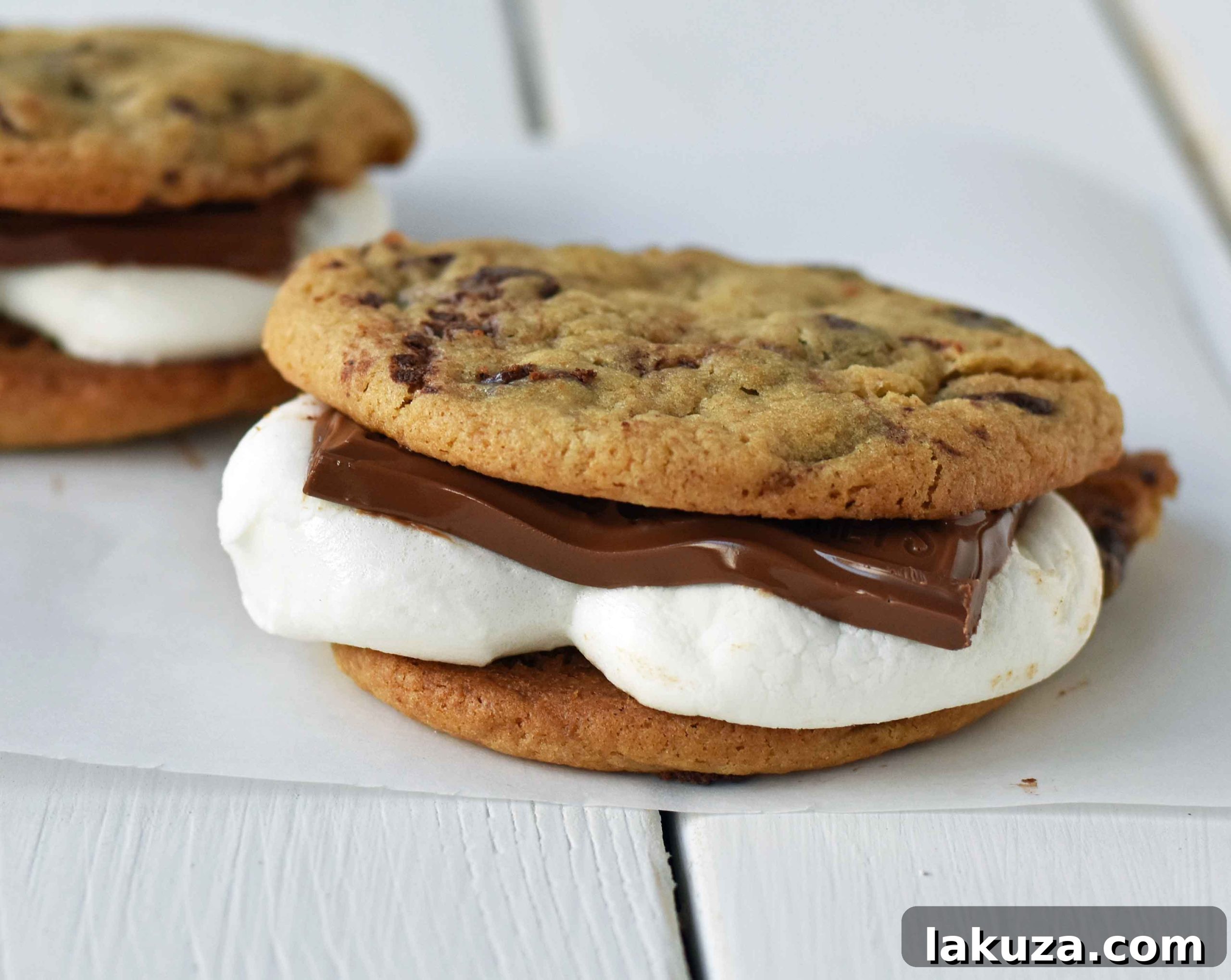Ultimate S'mores Chocolate Chip Cookies 2 Chocolate Chip Cookie S'mores: Warm, homemade chocolate chip cookies sandwiched with melted toasted marshmallow and rich milk chocolate. The ultimate s'mores dessert for any occasion.