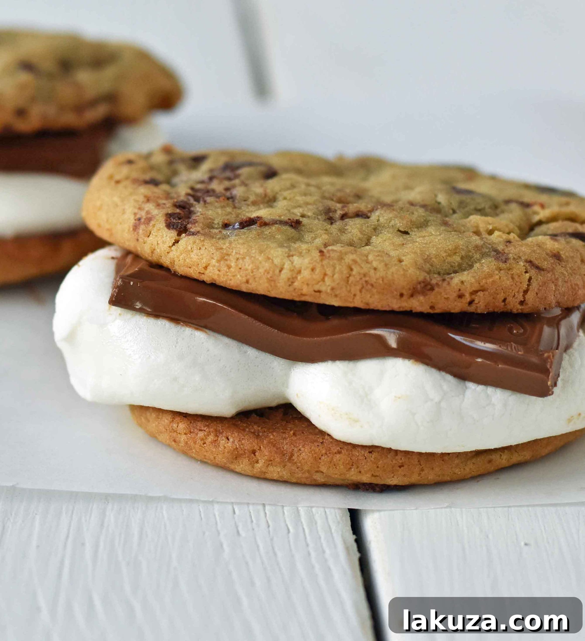 Ultimate S'mores Chocolate Chip Cookies 3 Two Chocolate Chip Cookie S'mores stacked, showcasing the golden-brown toasted marshmallow and rich melted chocolate filling, ready to be enjoyed.