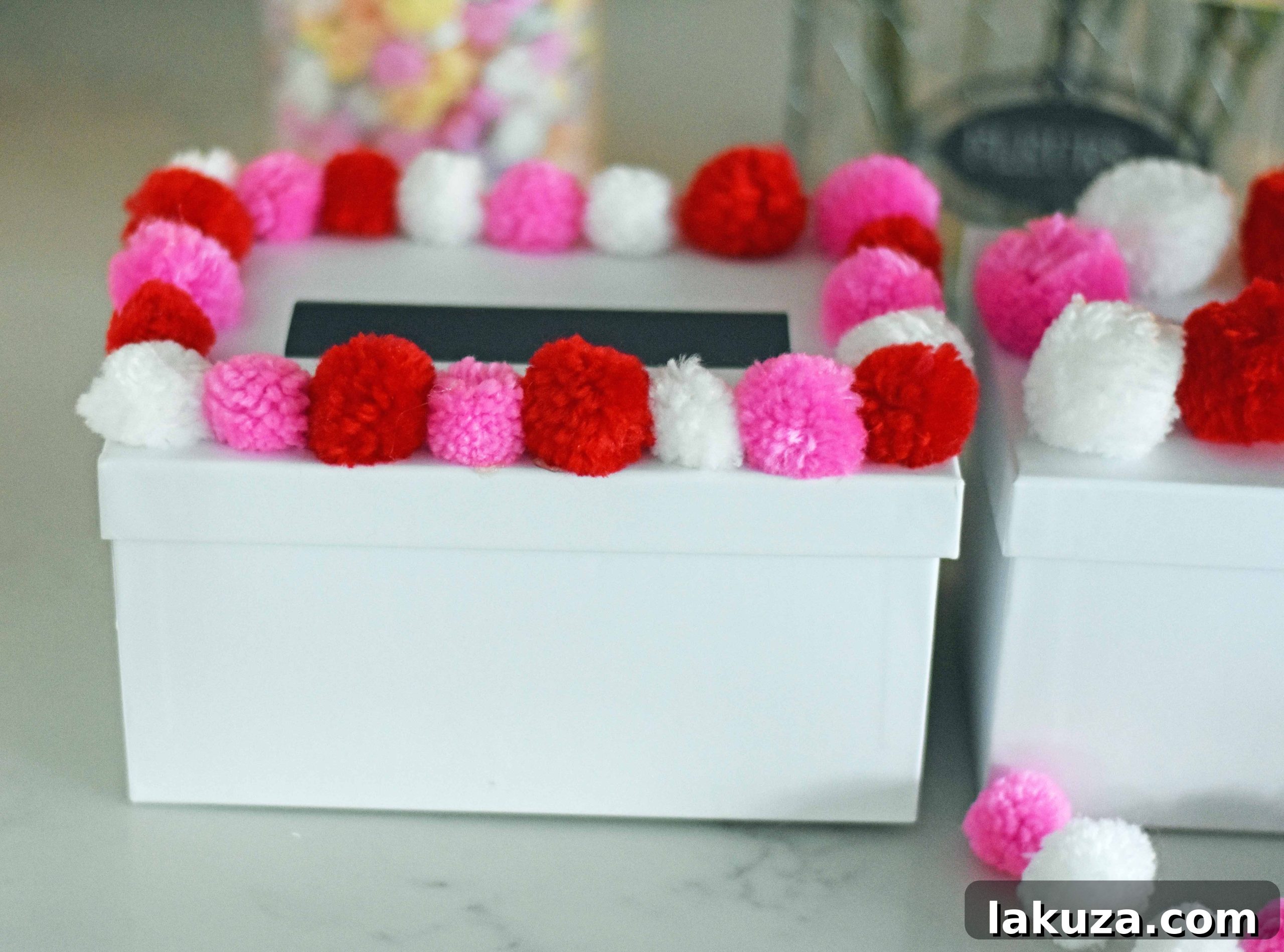 Creating Magical Valentine's Memories with Your Kids 18 How to decorate Valentine's Day boxes with pom poms. Pom Poms Valentine's Day boxes. Easy Valentine's Day boxes for school. Valentine's Day decorating ideas. www.modernhoney.com