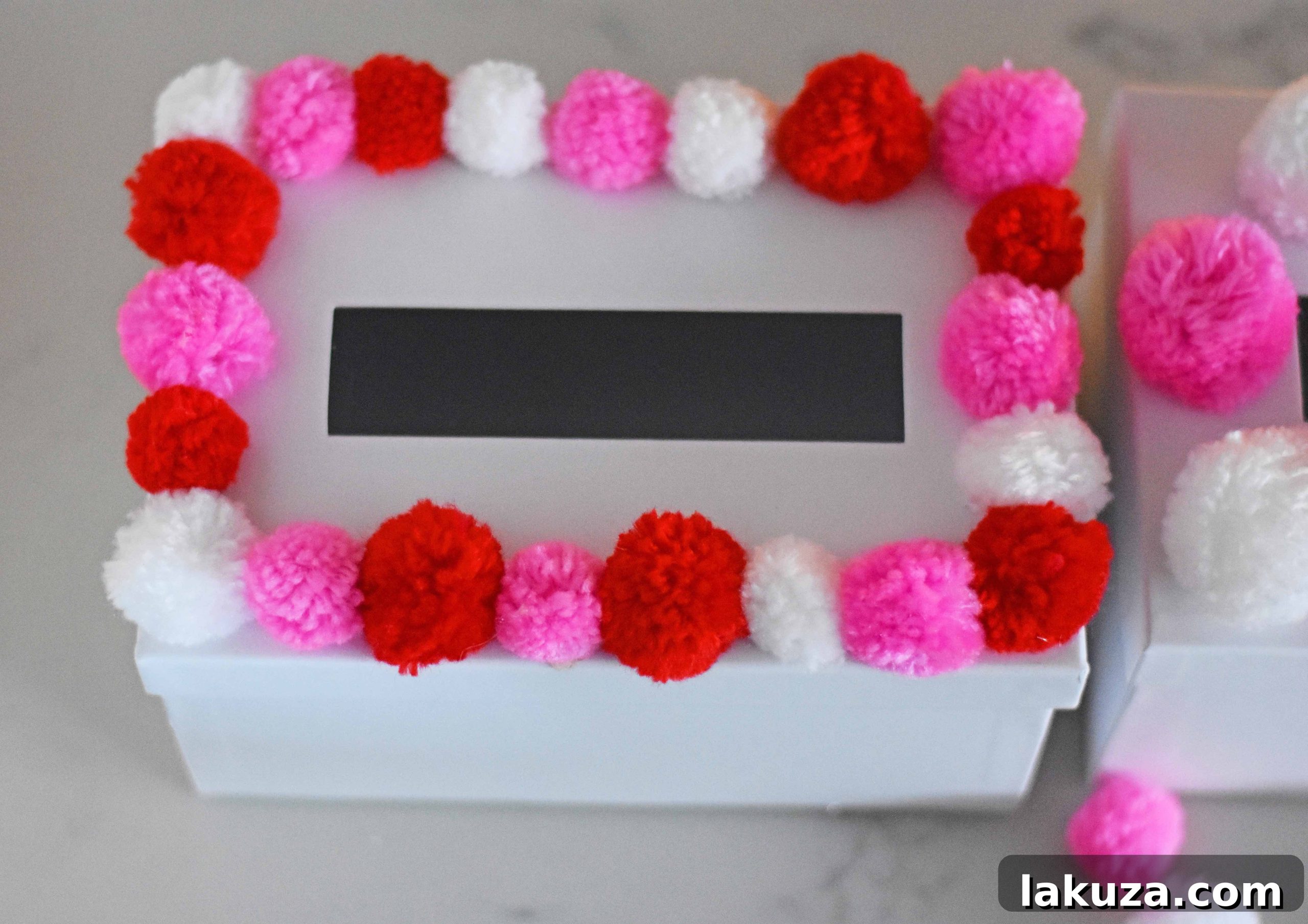 Creating Magical Valentine's Memories with Your Kids 19 How to decorate Valentine's Day boxes with pom poms. Pom Poms Valentine's Day boxes. Easy Valentine's Day boxes for school. Valentine's Day decorating ideas. www.modernhoney.com