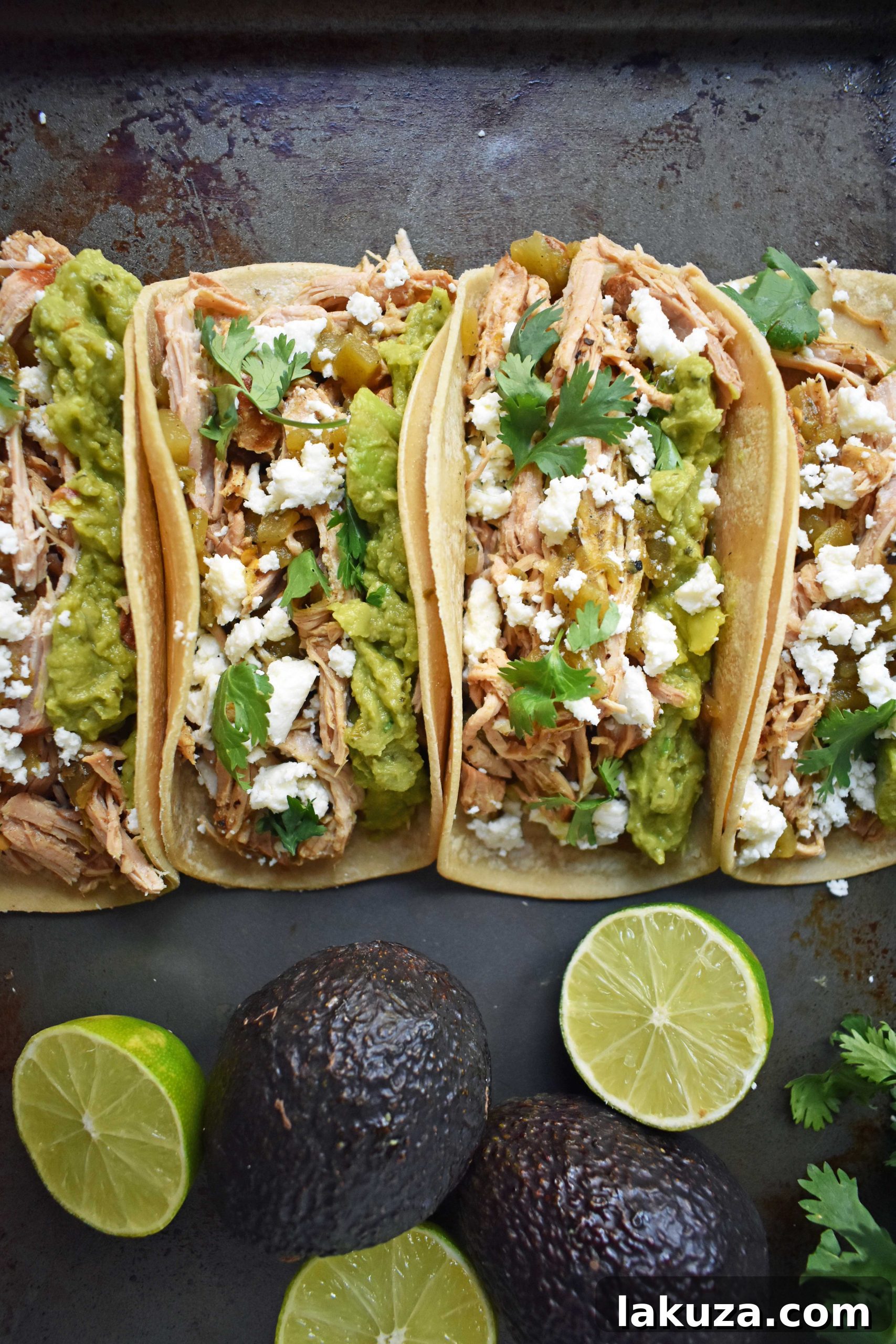 A close-up of Green Chili Pork Carnitas Tacos in a rustic setting, highlighting the crispy-edged, slow-cooked pork, fresh green chilies, and colorful toppings, making it an irresistible meal.