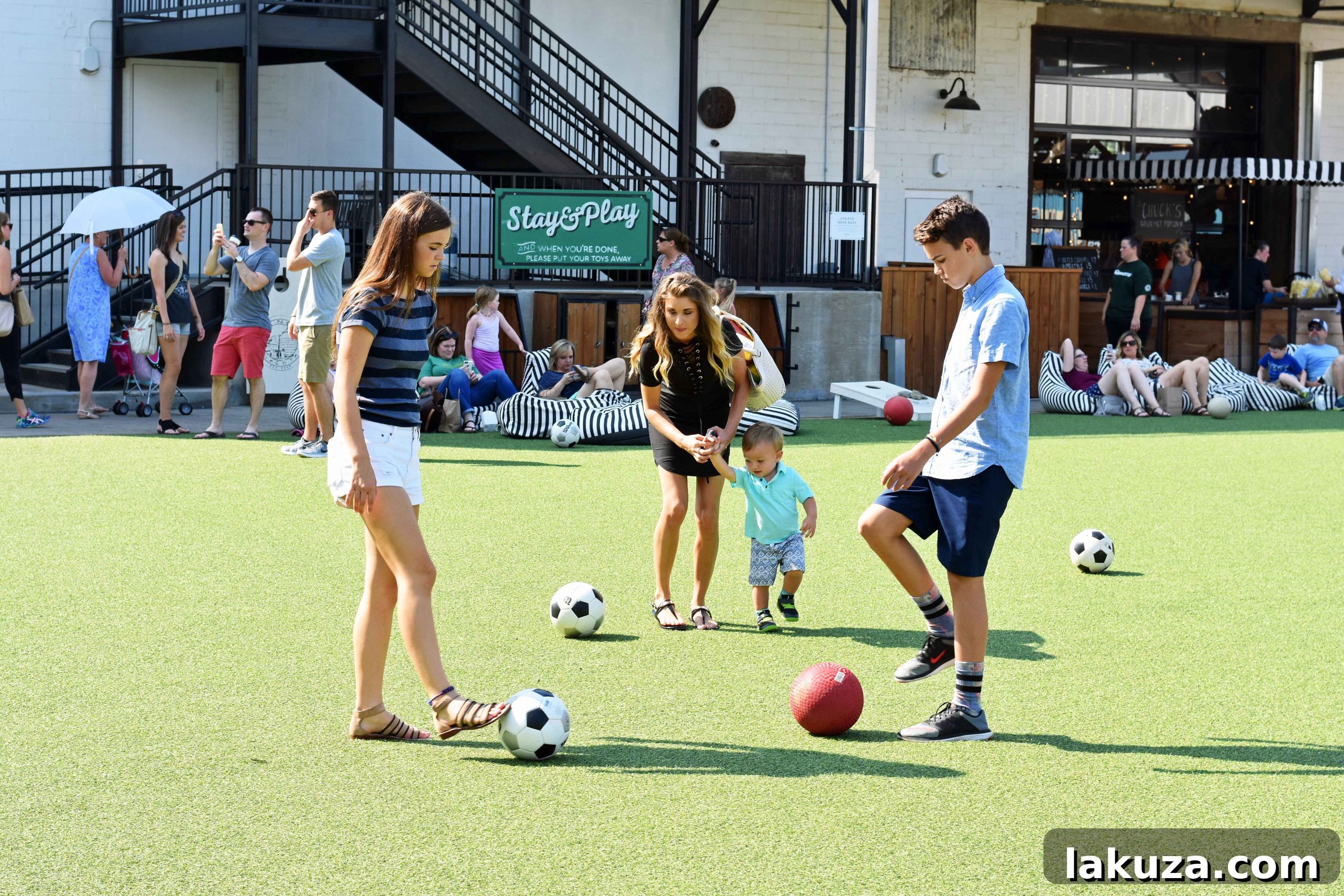Visitors relaxing on bean bag chairs on the lawn, enjoying the ambiance of Magnolia Market