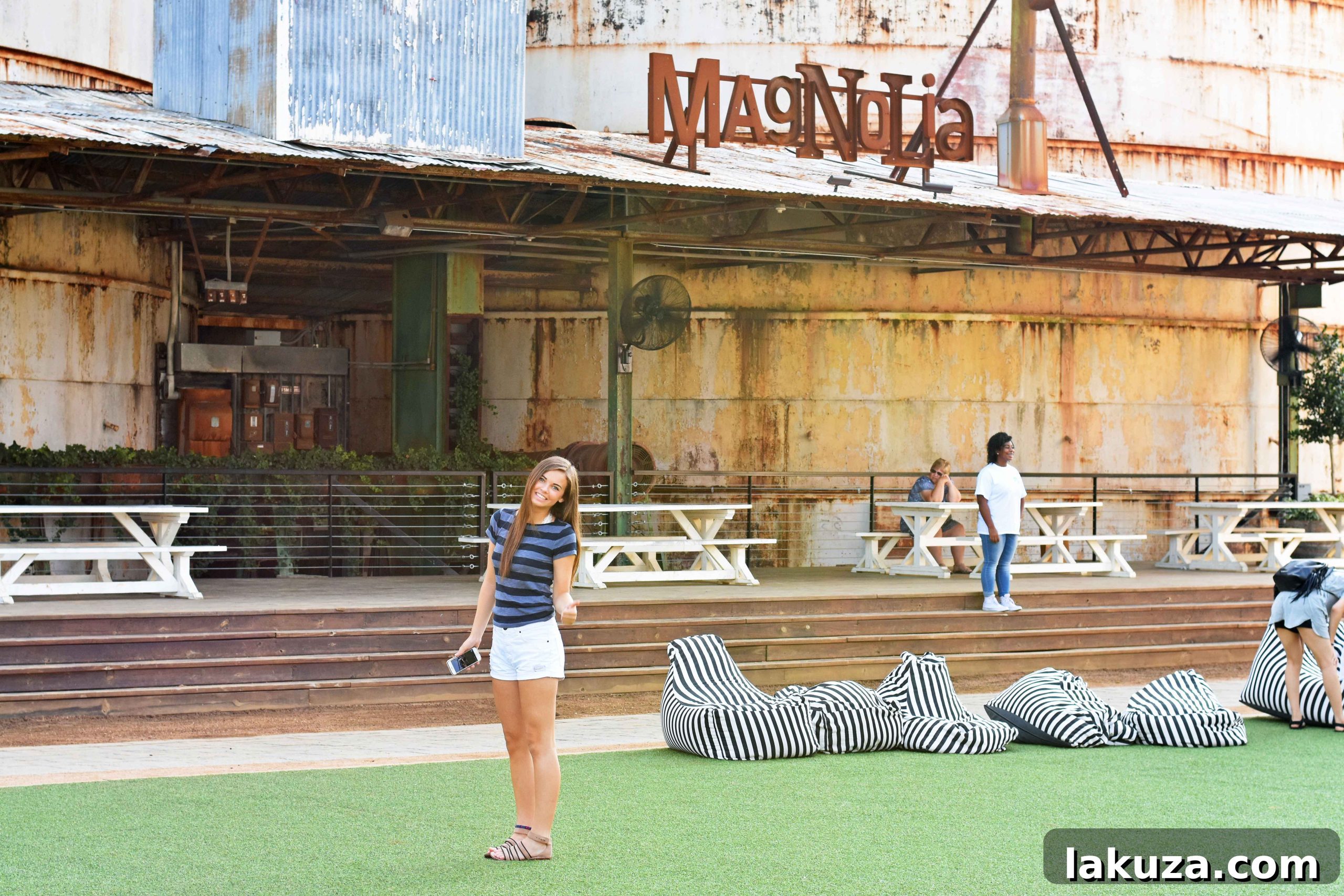 A vibrant sign for Magnolia Market at the Silos, welcoming guests to the destination