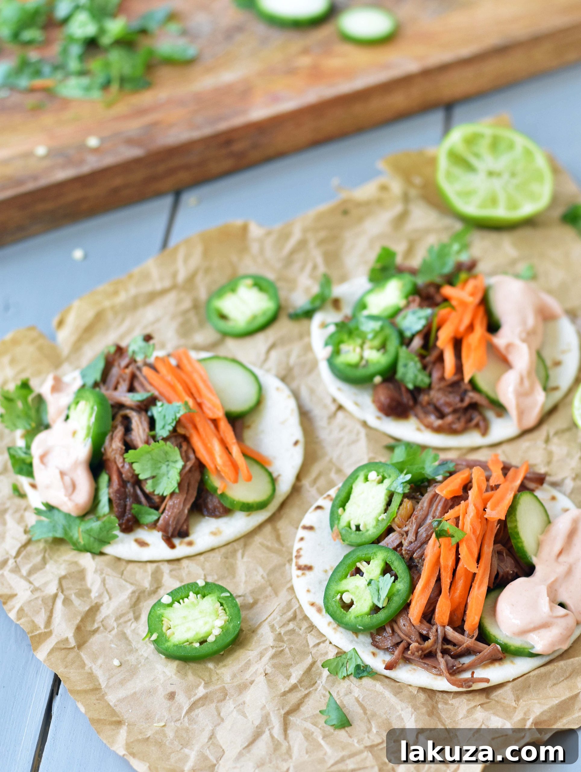 Side view of Korean Beef Taco filling with shredded beef and toppings