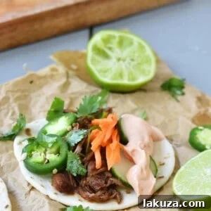 Slow Cooker Korean Beef Tacos. Slowly simmered korean beef with asian spices and topped with crunchy slaw.