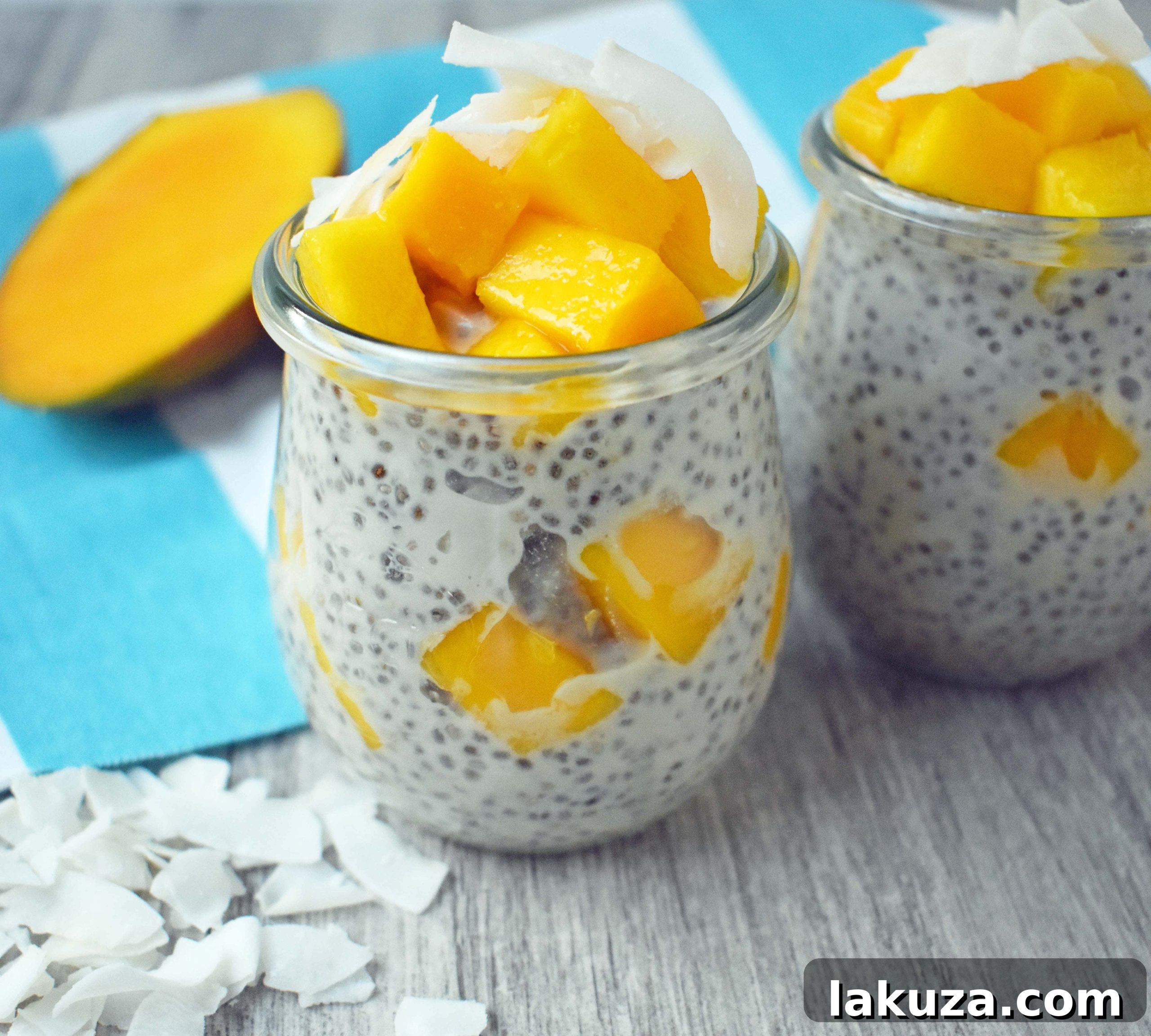 Finished Coconut Mango Chia Pudding, a gluten-free, sugar-free, dairy-free dessert. Omega rich chia seeds soaked in coconut milk and sweetened with real maple syrup. Topped with unsweetened coconut flakes and fresh mango for a healthy tropical treat.