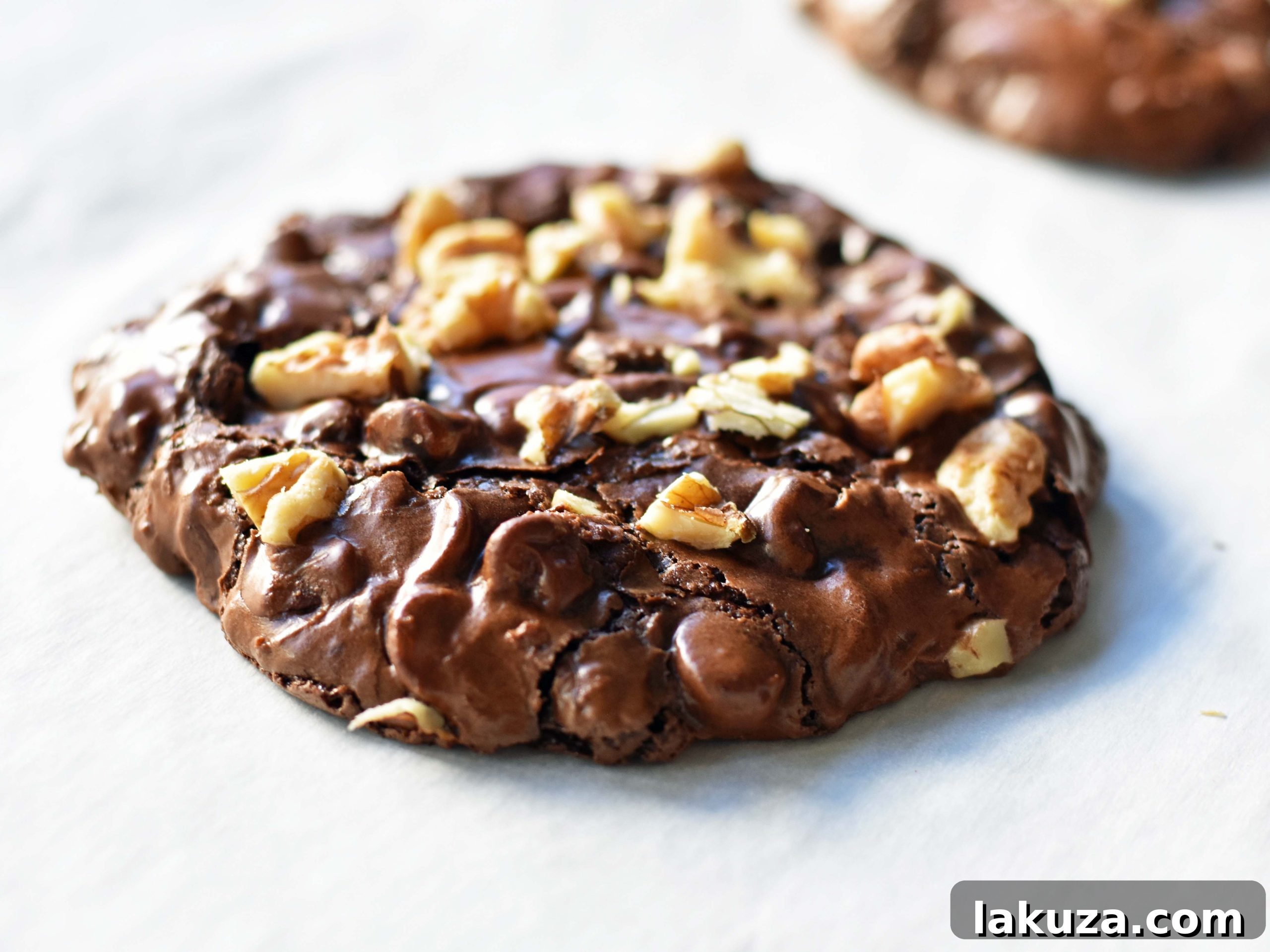 Fudgy Chocolate Delights 3 Close-up of baked flourless chocolate brownie gluten-free cookies, showcasing their chewy texture and melted chocolate chips.