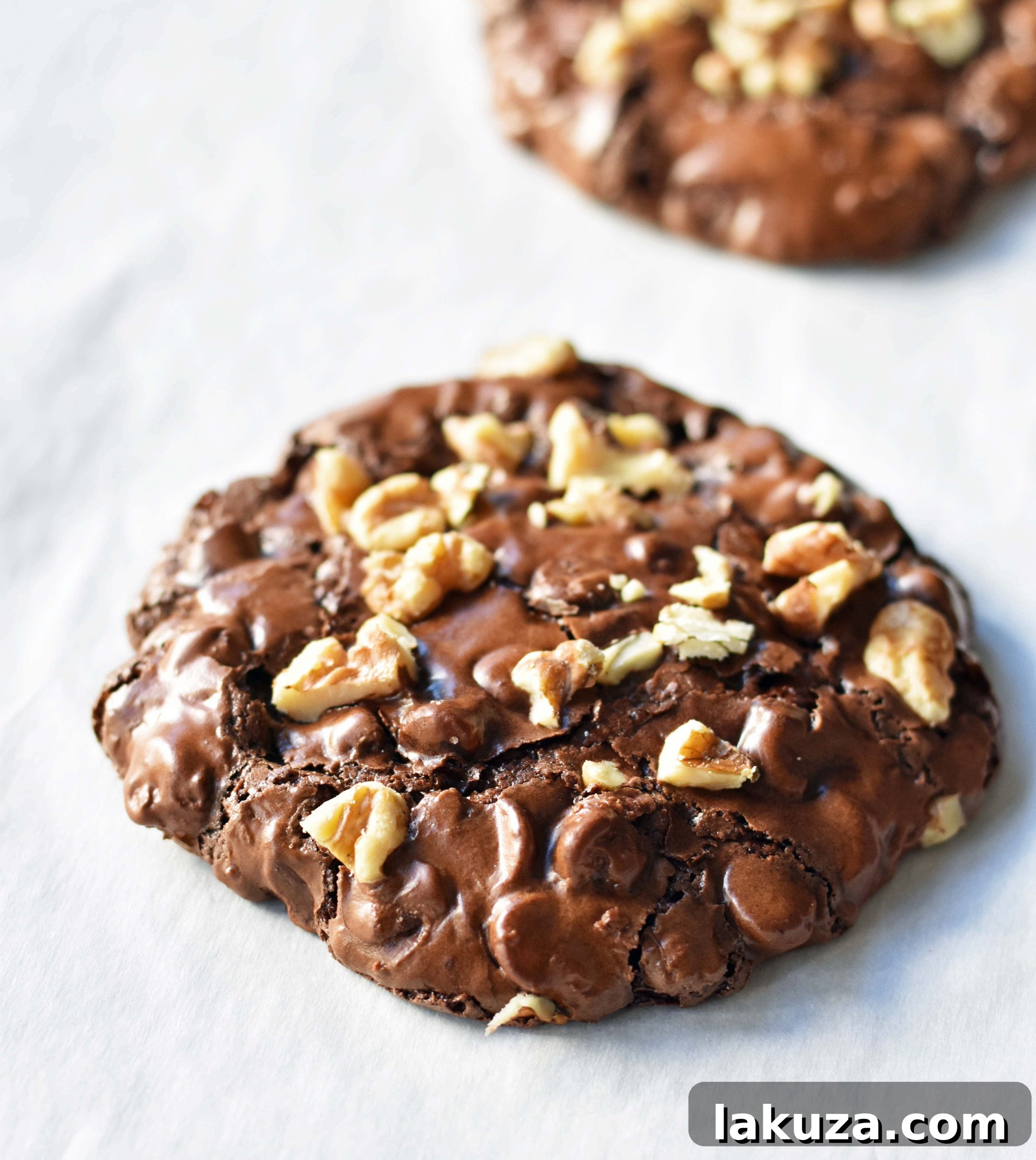 Fudgy Chocolate Delights 4 Assortment of key ingredients for making flourless chocolate brownie cookies, including powdered sugar, cocoa, eggs, and walnuts.