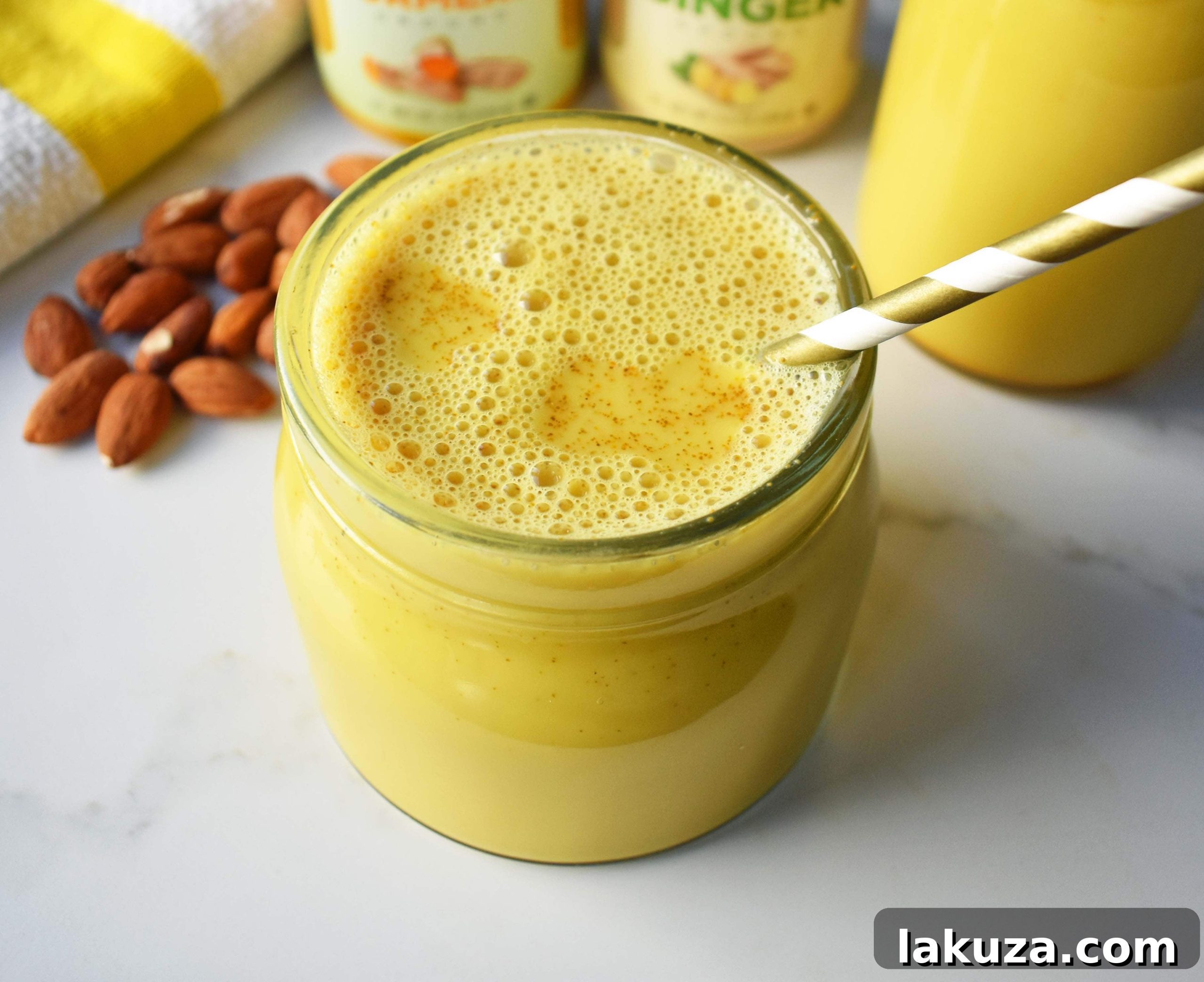 Golden Milk Elixir and Natural Paths to Serenity 3 Ingredients for making Golden Milk (turmeric tea), including almond milk, fresh turmeric, ginger, and cinnamon sticks.