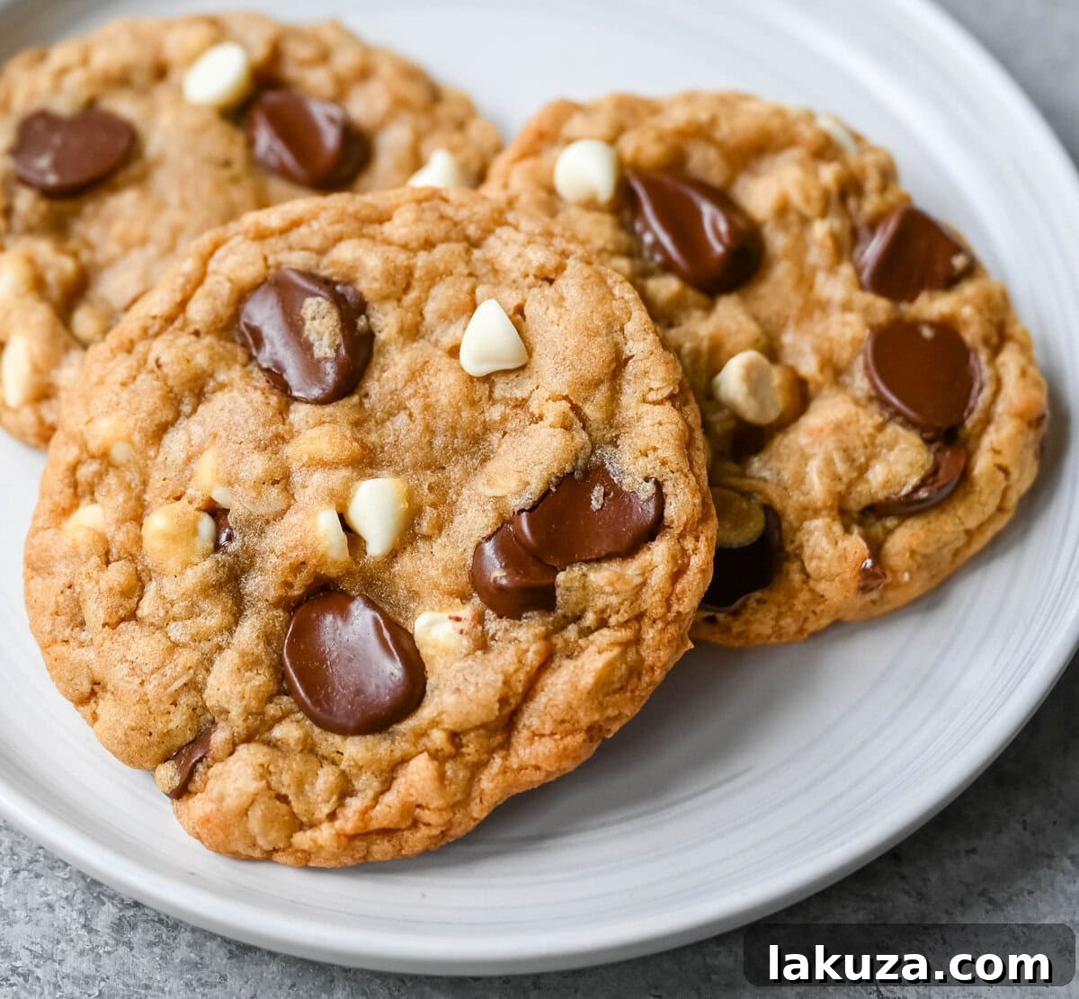 Close-up of baked Marry Me Cookies featuring oatmeal, dark and white chocolate chips, showcasing the irresistible texture of these saucepan brown butter cookies.