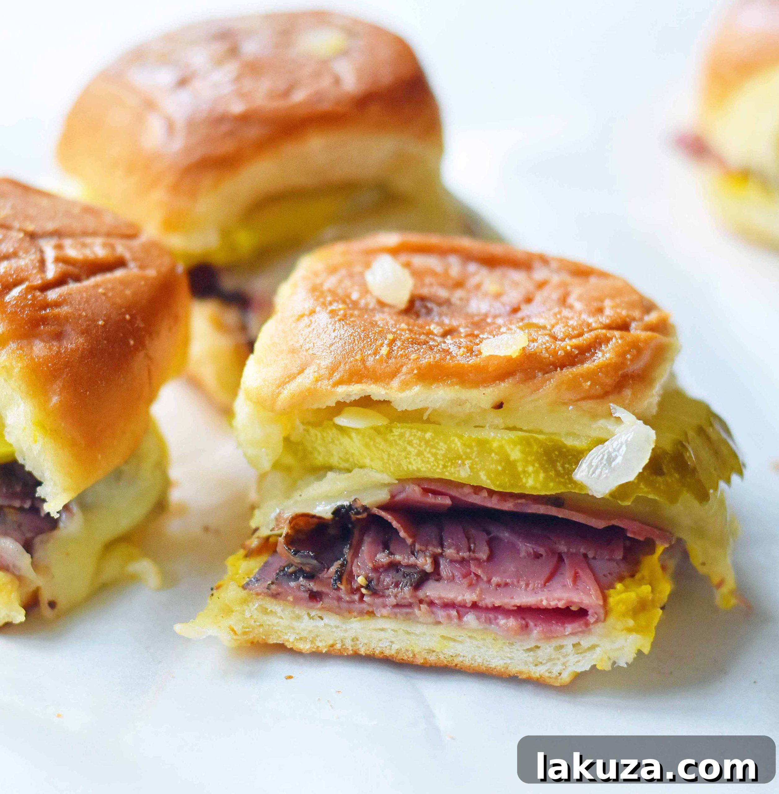 Tailgate Touchdown Hot Pastrami and Swiss Sliders 2 Delicious Hot Pastrami and Swiss Tailgate Sliders, perfect for any gathering. Featuring savory pastrami, creamy Swiss cheese, and tangy mustard, all on garlic buttered Hawaiian rolls, baked until golden and irresistible. A must-try easy recipe for football season, parties, or a cozy dinner.