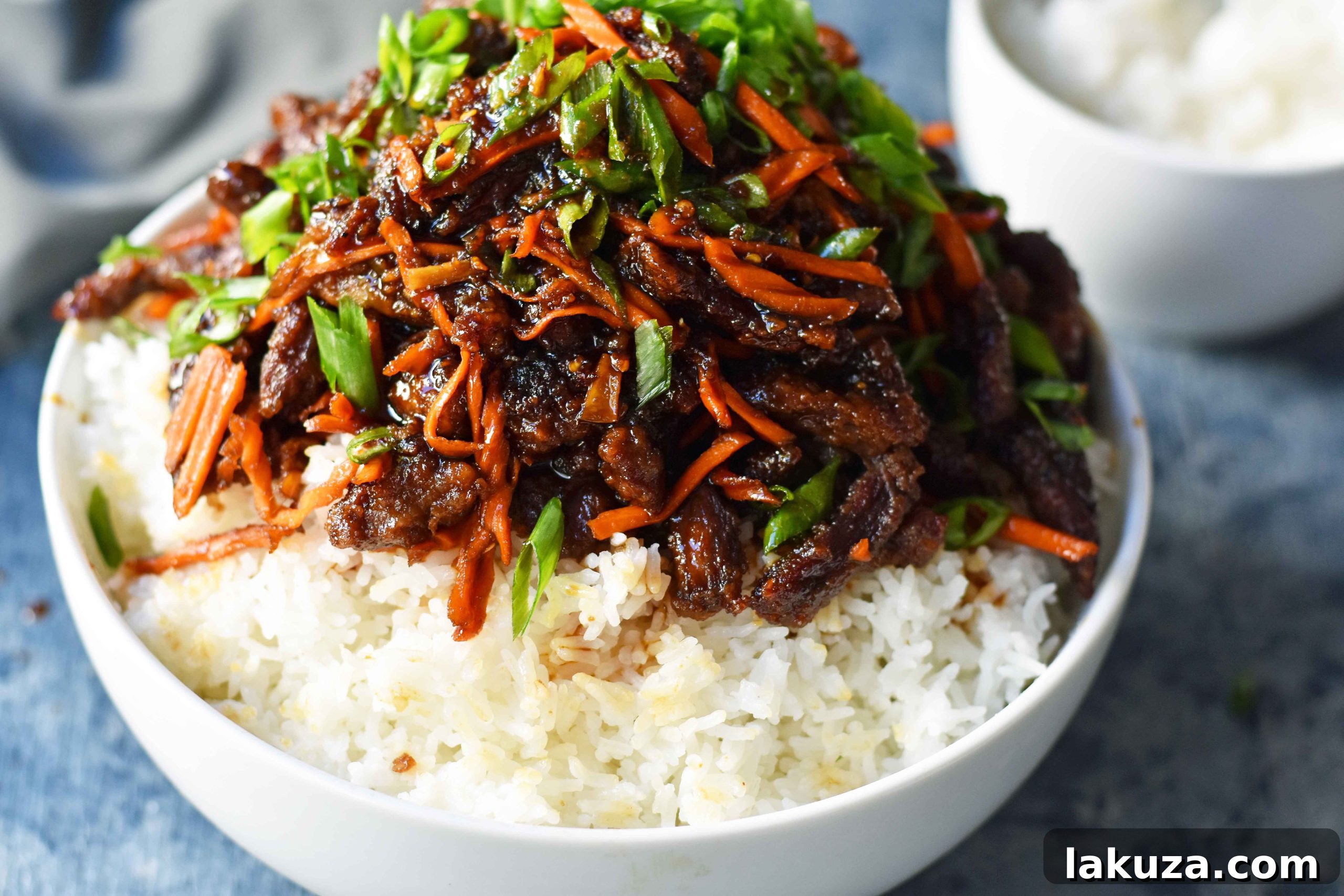 Mongolian Beef, a homemade version, showcasing the rich sauce and tender beef slices, served family-style.
