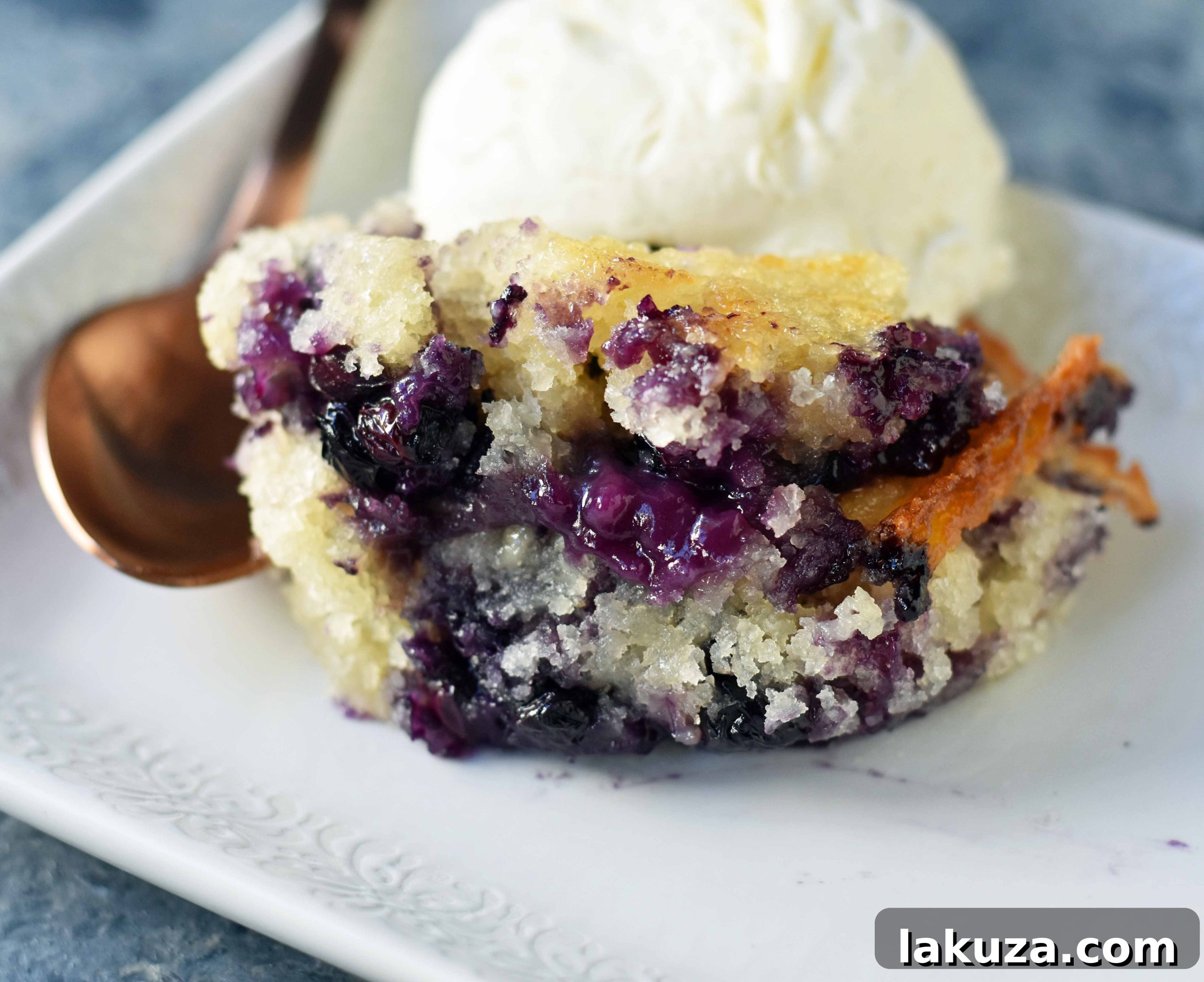 Close-up of the delicious Texas-Style Blueberry Cobbler showing its golden crust and juicy fruit filling.