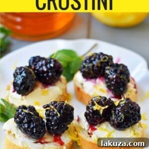 Blackberry and Lemon Mascarpone Crostini is made with a toasted french baguette, creamy mascarpone cheese, sugar marinated blackberries, lemon zest, and a drizzle of honey. A perfect appetizer for a bridal shower, baby shower, party, festive holiday gathering, or at home. A sophisticated and beautiful quick and easy appetizer.