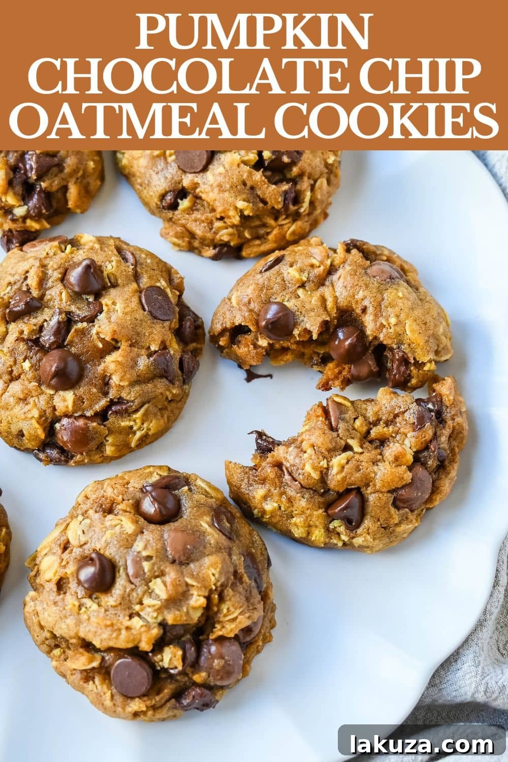 A beautifully composed flat lay of Pumpkin Oatmeal Chocolate Chip Cookies, autumn leaves, and a warm beverage, perfect for a Pinterest pin.