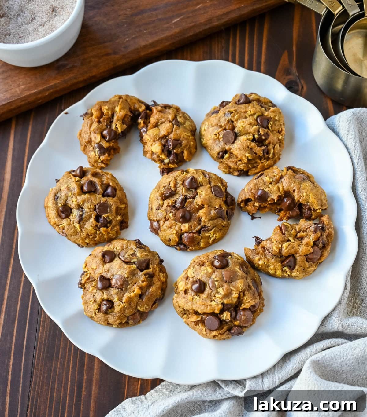 Close-up of a single Pumpkin Oatmeal Chocolate Chip Cookie, showing its moist interior and the inviting texture created by oats and chocolate chips.