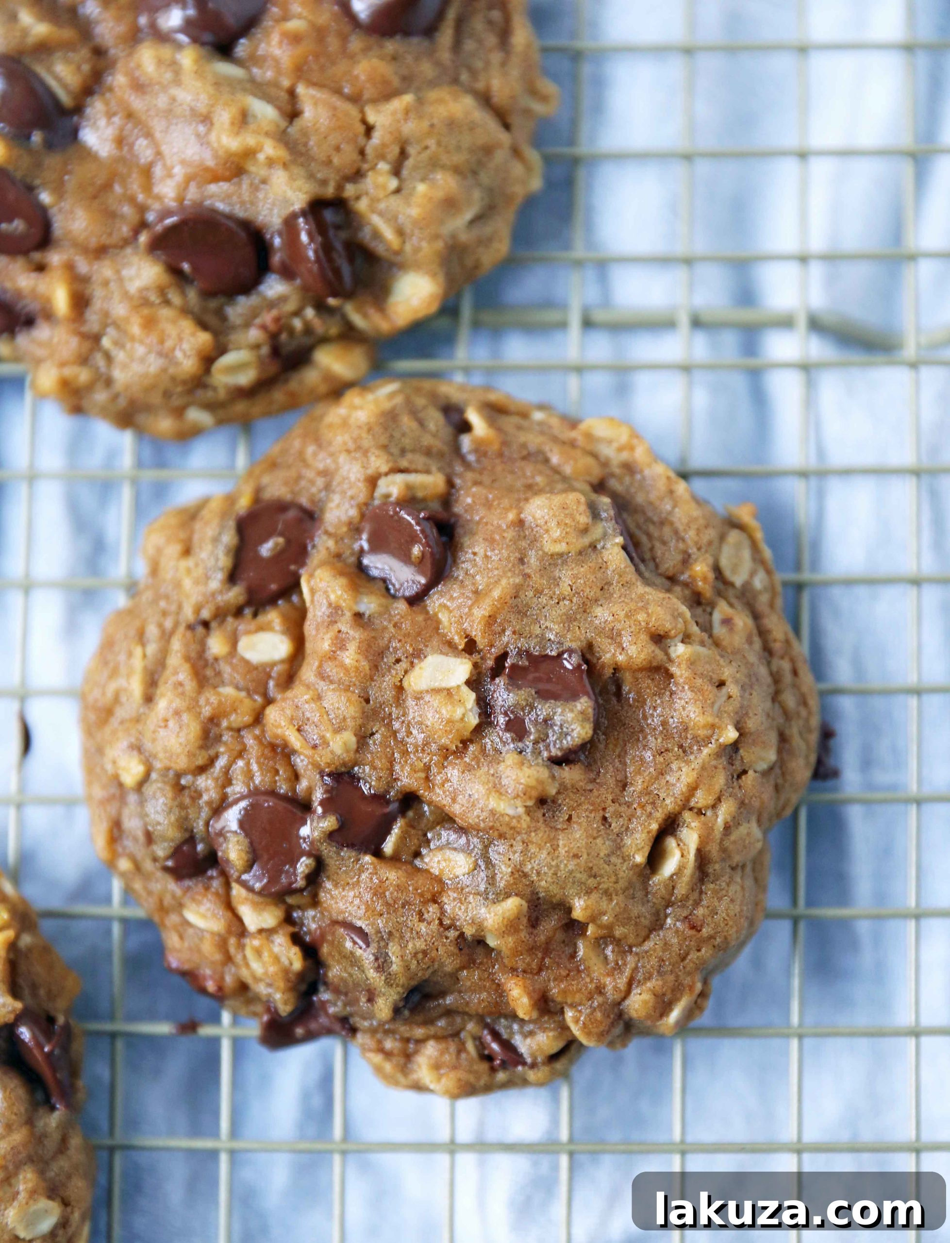 Platter of warm, spiced Pumpkin Chocolate Chip Oatmeal Cookies with fall decor, highlighting their golden-brown edges and soft centers.