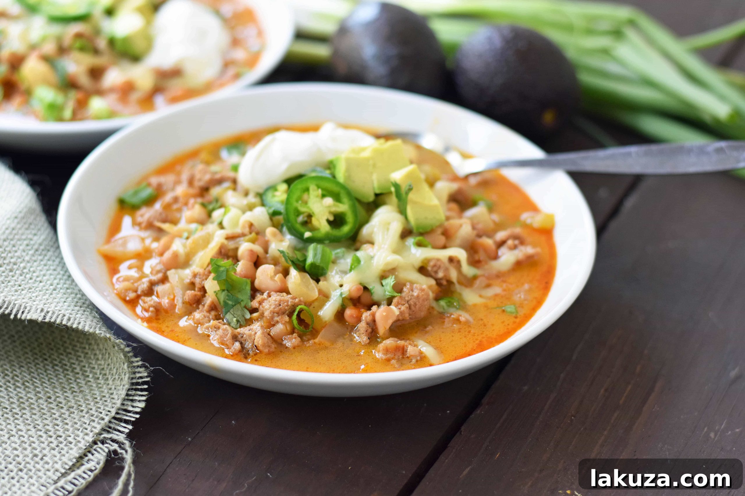 Ingredients for White Bean Turkey Chili laid out, showing fresh onions, ground turkey, and spices, emphasizing ease of preparation.