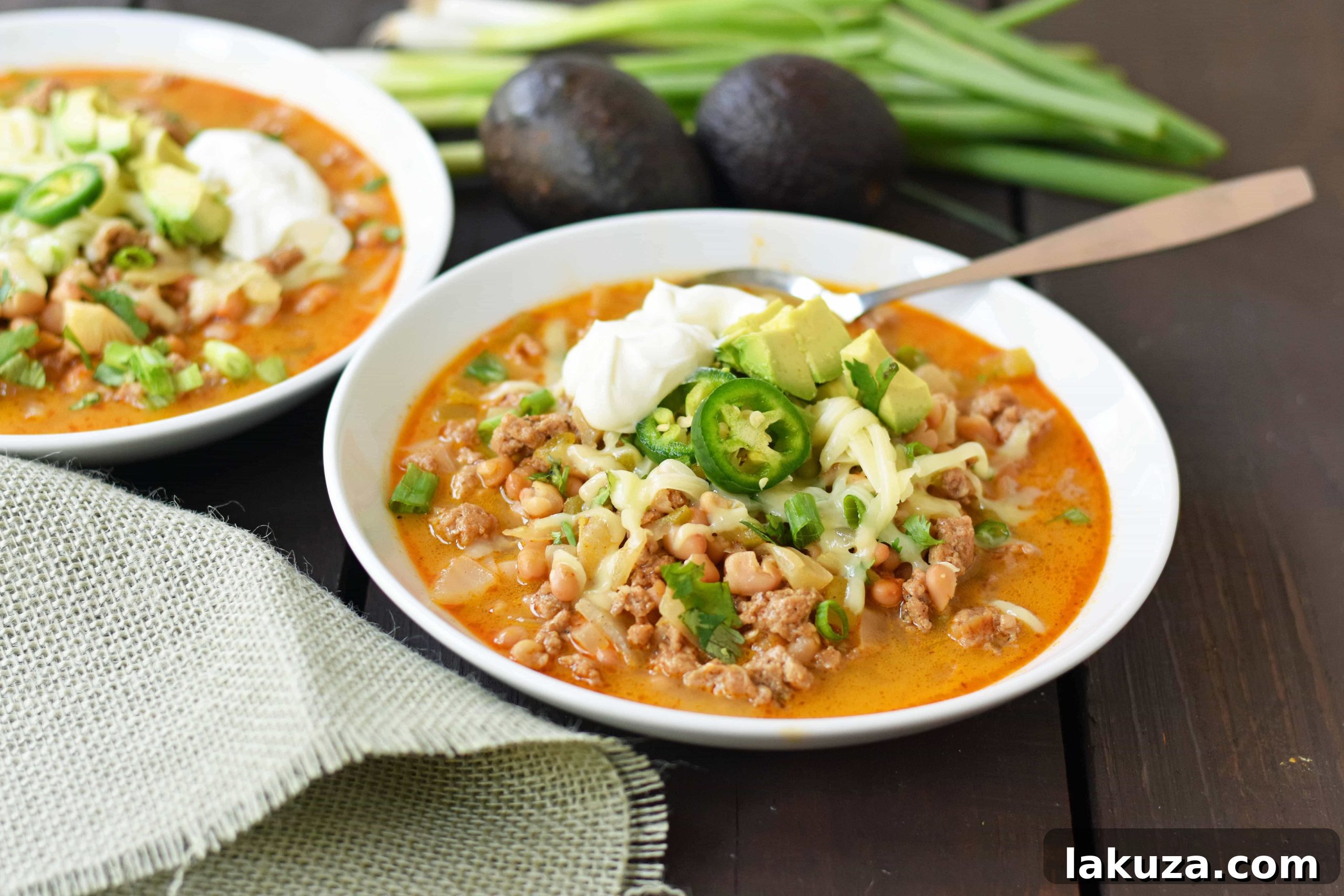 A large pot of White Bean Turkey Chili simmering, showing the rich broth and beans, highlighting a healthy and quick meal option.