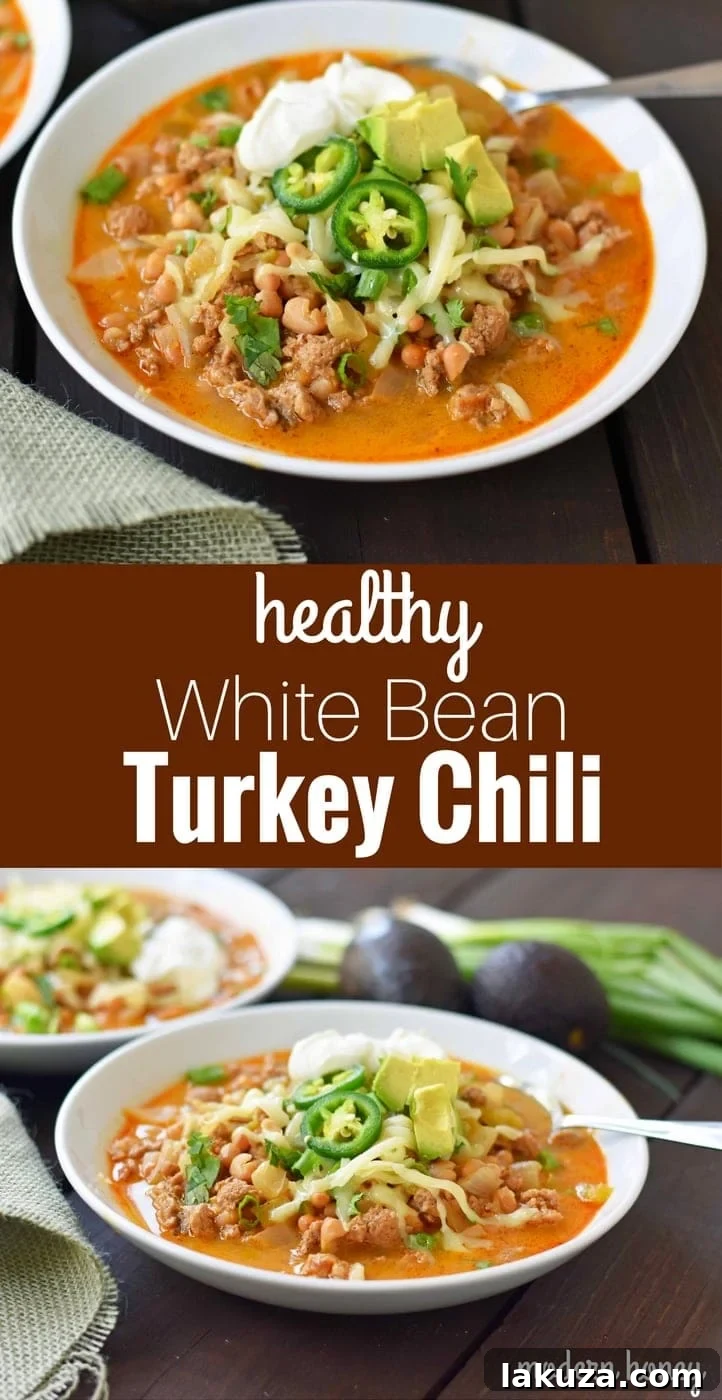 A beautifully presented bowl of White Bean Turkey Chili with fresh cilantro, avocado, and sour cream on top, ready to be enjoyed.