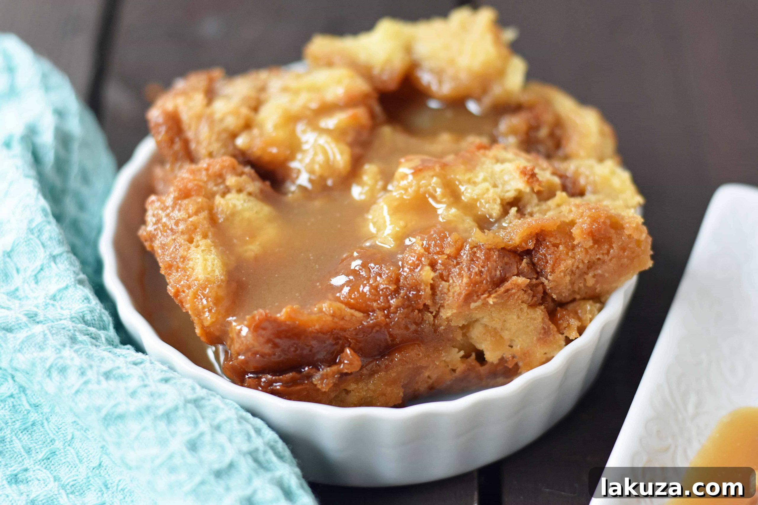 Salted Caramel Bread Pudding Delight 5 Close-up of Salted Caramel Bread Pudding garnished with whipped cream and caramel sauce.