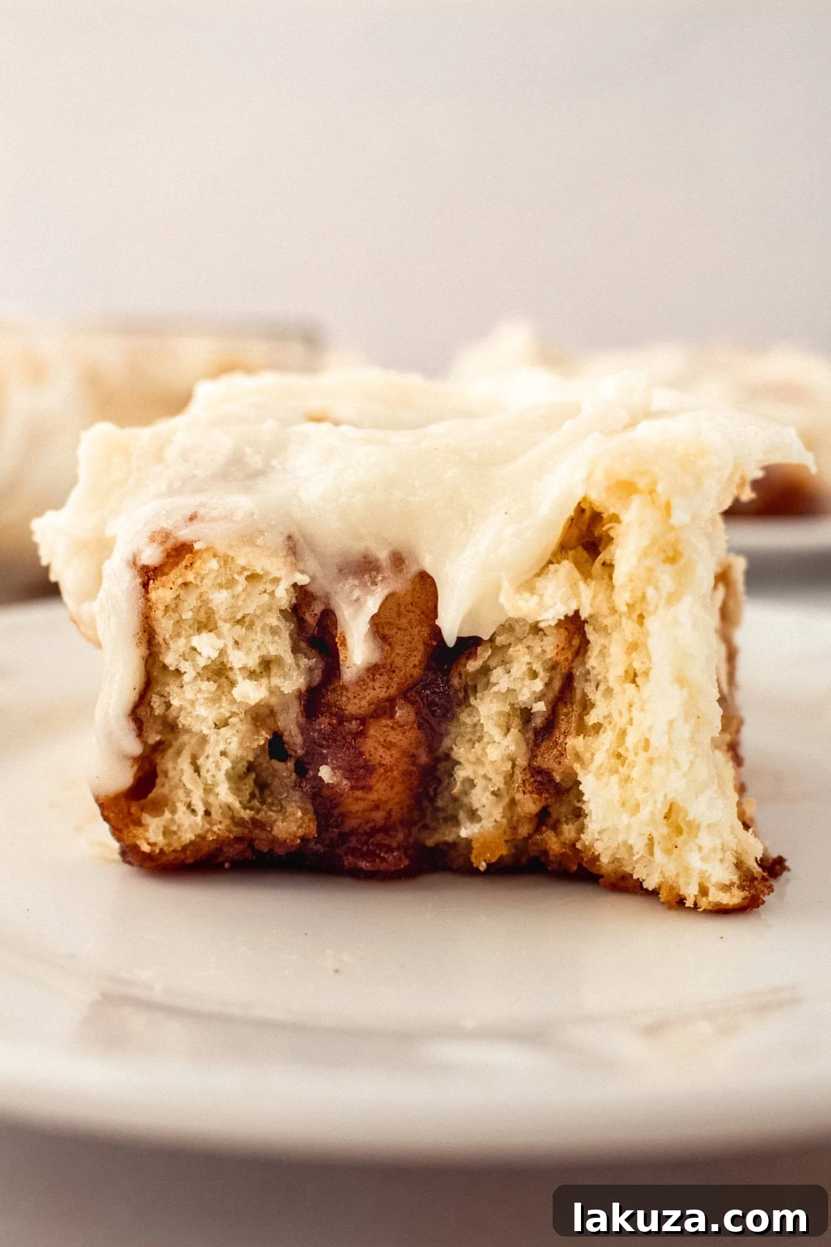 Heavenly Homemade Cinnamon Buns 2 A close-up shot of Hayley's Famous Cinnamon Rolls, showcasing their warm, gooey texture, rich brown sugar filling, and generous cream cheese icing, perfect for a homemade breakfast.
