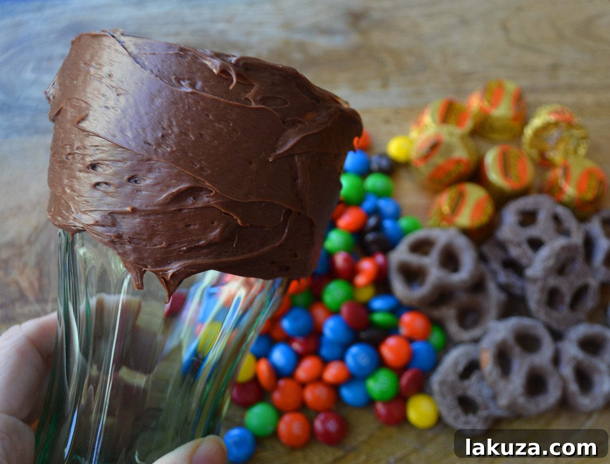 Recreate Black Tap's Jaw-Dropping Milkshakes 4 First step for homemade Black Tap milkshakes: spreading chocolate frosting on the outside of the glass to act as an adhesive for toppings.