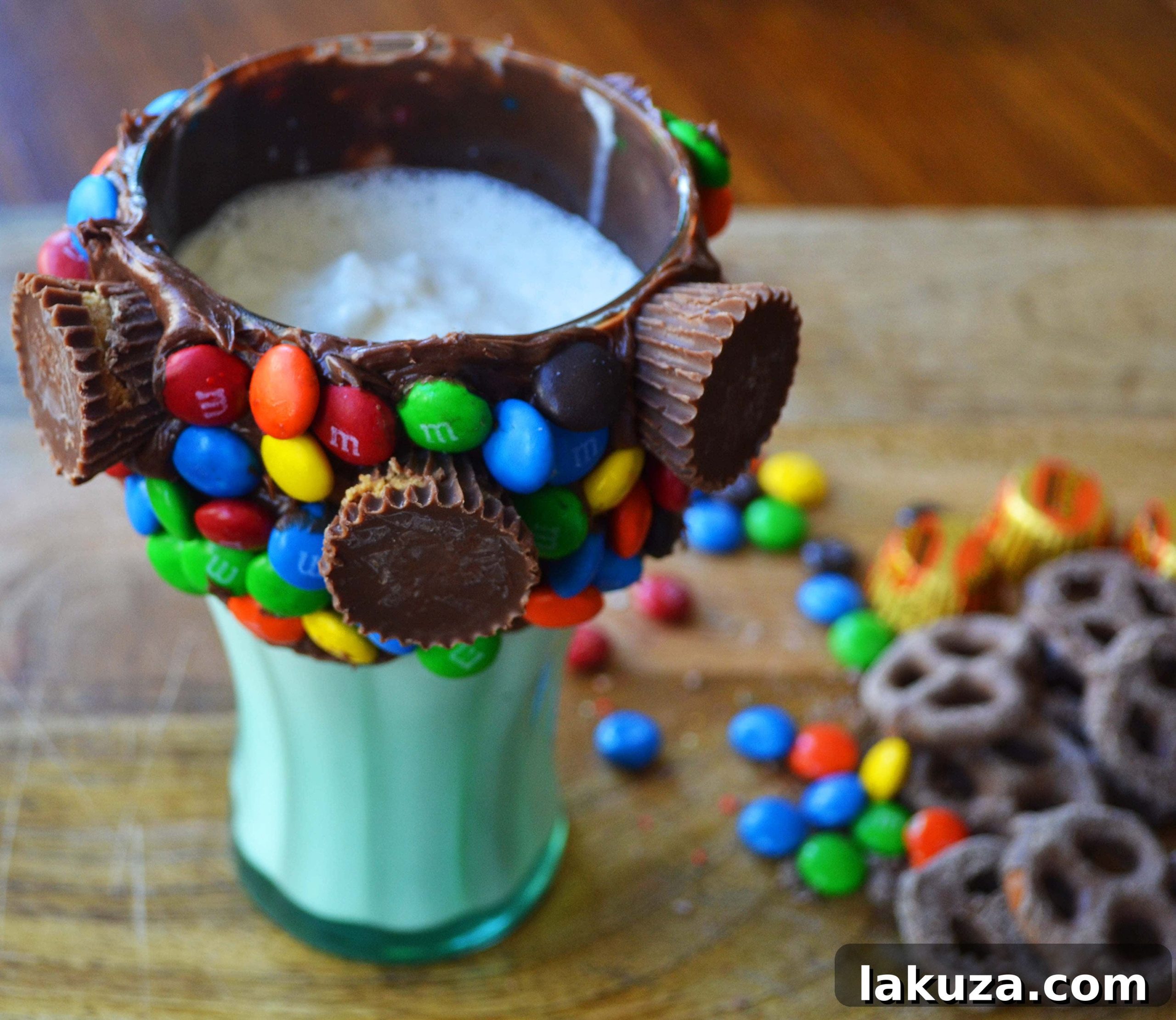 Recreate Black Tap's Jaw-Dropping Milkshakes 6 Filling a decorated glass with a freshly blended creamy milkshake, showcasing the frosting and candy rim adhered to the glass.