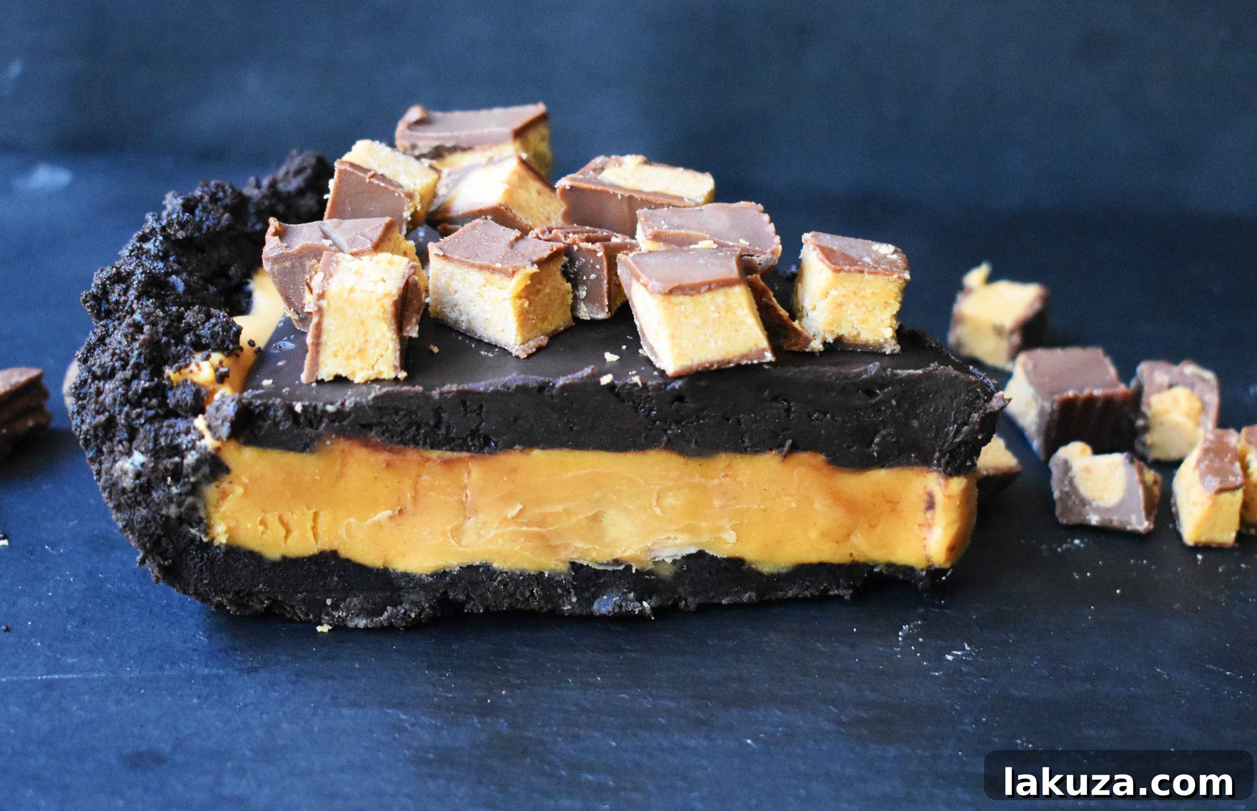 Reese's Chocolate Peanut Butter Cup Pie featuring an OREO cookie crust, creamy peanut butter filling, rich chocolate ganache, and topped with Reese's Peanut Butter Cups. A no-bake dessert that's perfect for any occasion.