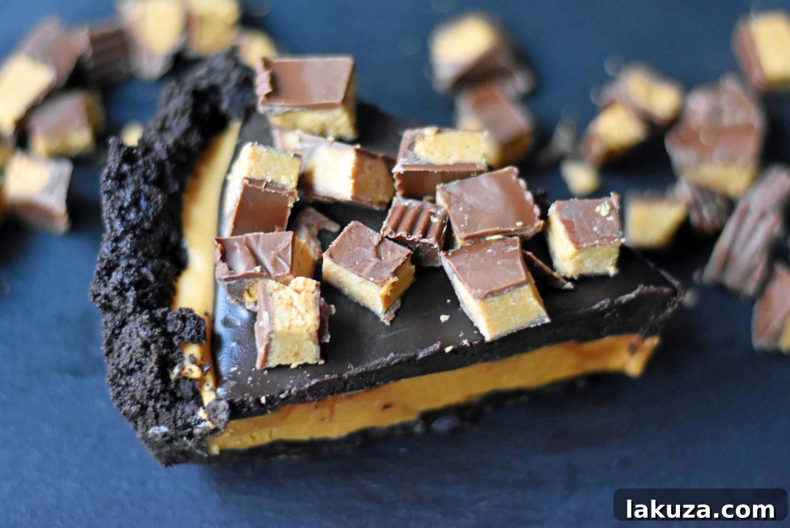 A close-up of the creamy peanut butter filling layered over the OREO crust, ready for the chocolate ganache topping.
