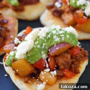 Chorizo Potato Puffy Tacos, an award-winning recipe by Melissa Stadler from the Pillsbury Bake-Off Contest. Perfectly topped with avocado tomatillo salsa and cotija cheese.