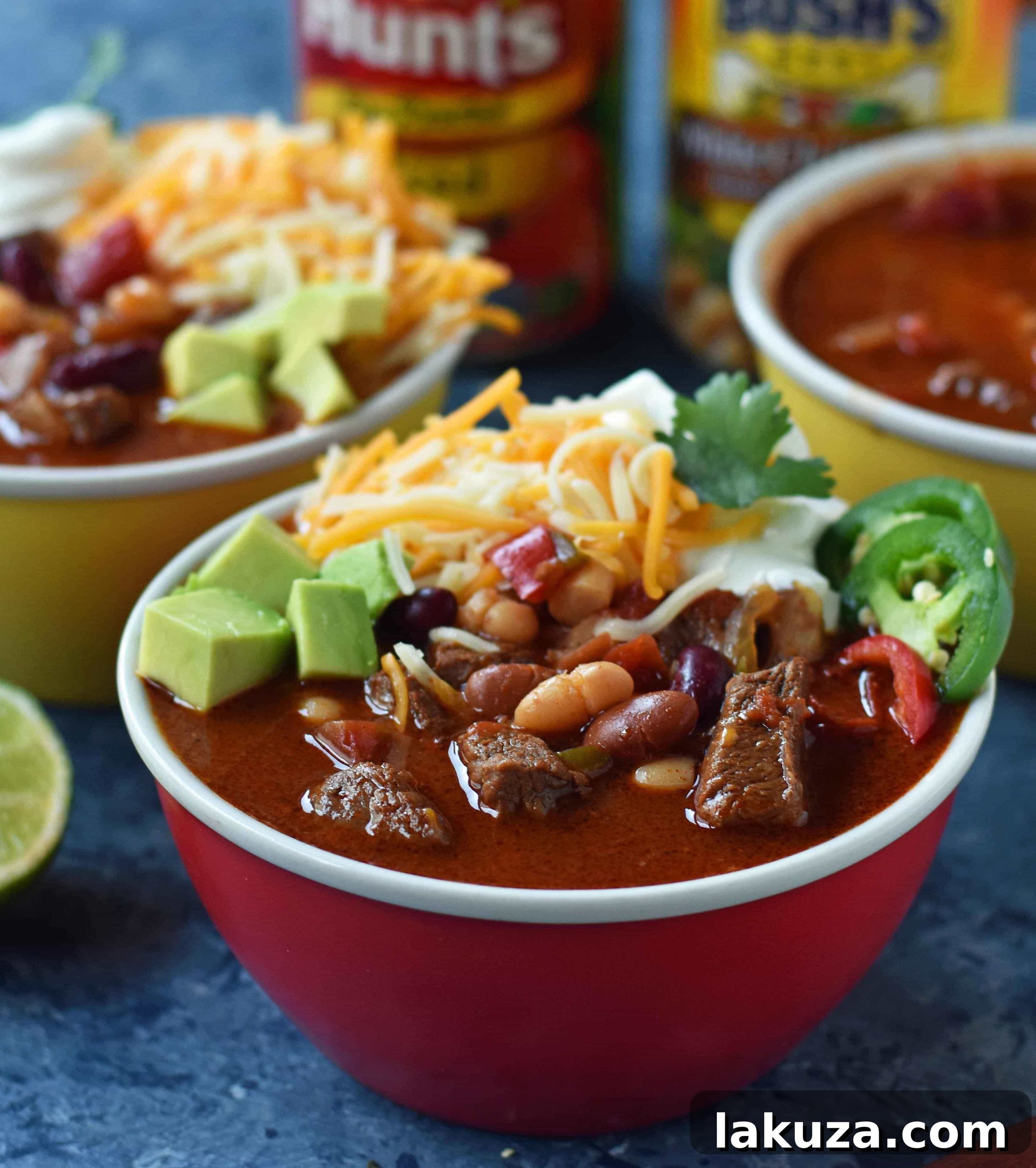 A bowl of MJ's Award-Winning Chili, garnished with fresh cilantro and cheese.