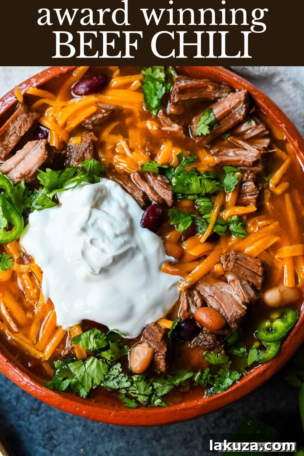 An overhead shot of a perfectly garnished bowl of MJ's Award-Winning Beef Chili.