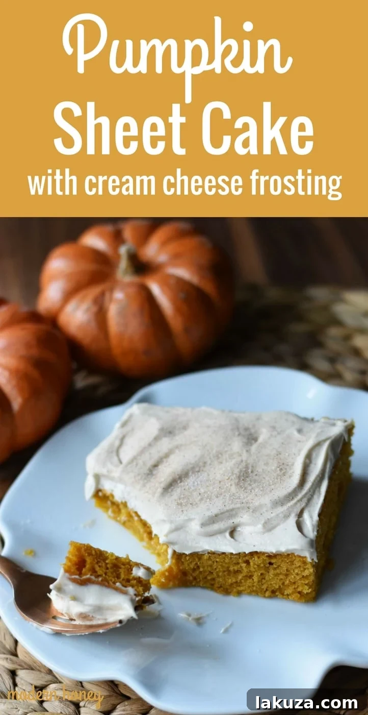 Golden Pumpkin Spice Cake with Cream Cheese Frosting 7 A stunning vertical shot of Pumpkin Sheet Cake with a thick layer of smooth cream cheese frosting, emphasizing its delicious appeal.