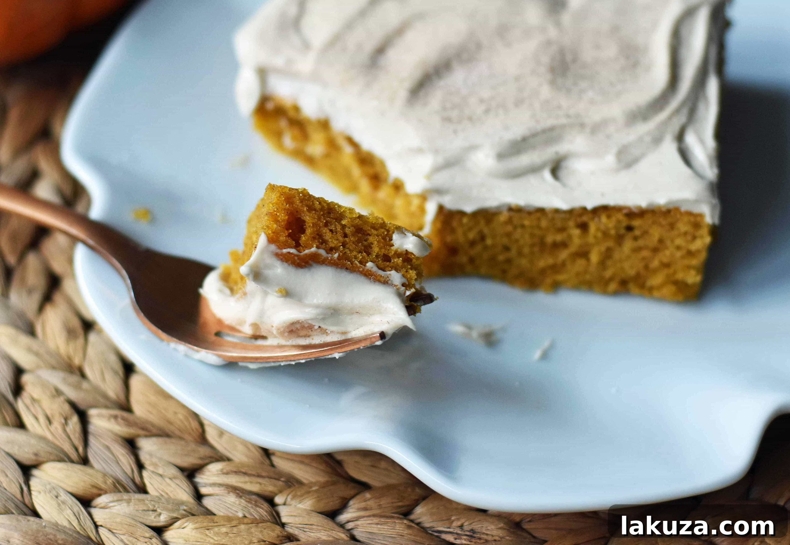 Golden Pumpkin Spice Cake with Cream Cheese Frosting 4 A festive Pumpkin Sheet Cake, generously frosted and garnished, perfect for fall celebrations or a casual family dessert.