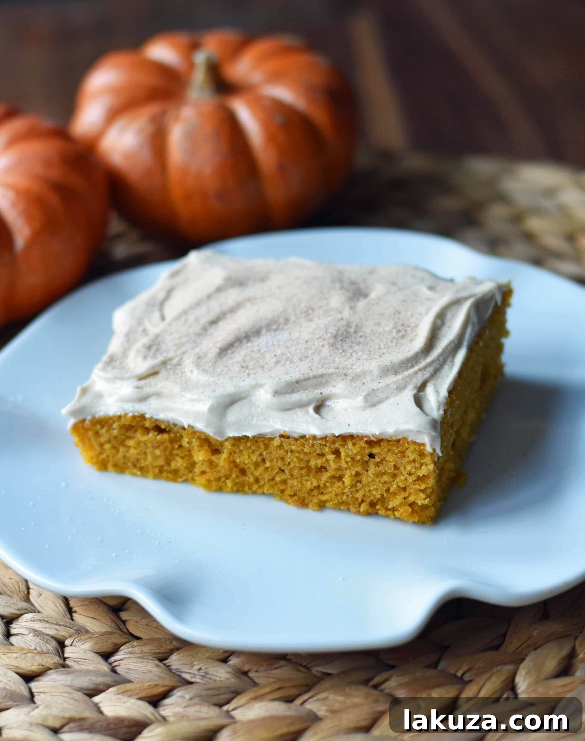 Golden Pumpkin Spice Cake with Cream Cheese Frosting 5 Freshly baked Pumpkin Sheet Cake adorned with a generous layer of homemade cream cheese frosting, ready for slicing.