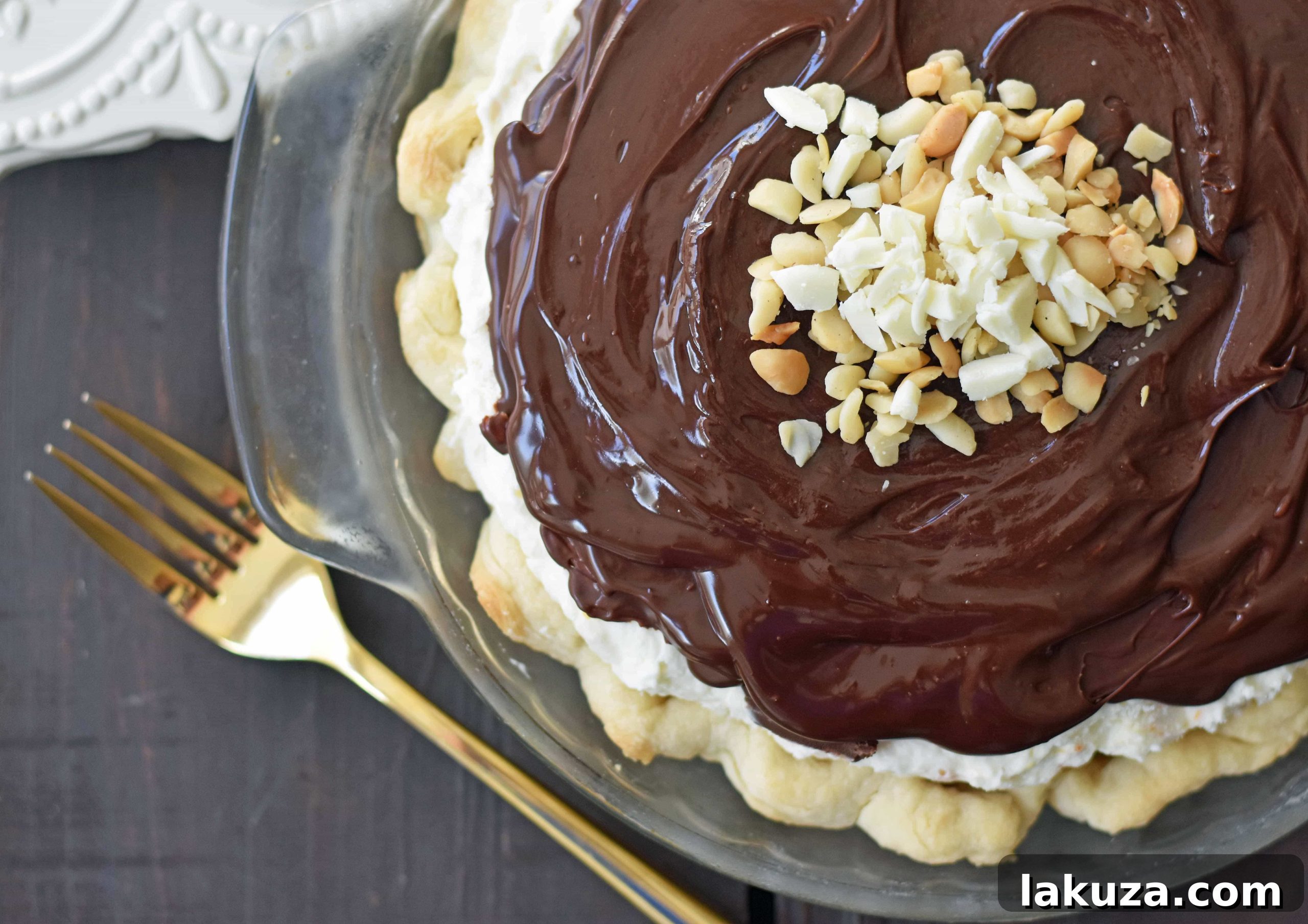 White Chocolate Macadamia Pie made with a fluffy white chocolate cream filling studded with orange zest and macadamia nuts and topped with a silky smooth chocolate ganache and freshly whipped cream. White Chocolate Orange Chocolate Ganache Pie. The BEST PIE ever! www.modernhoney.com
