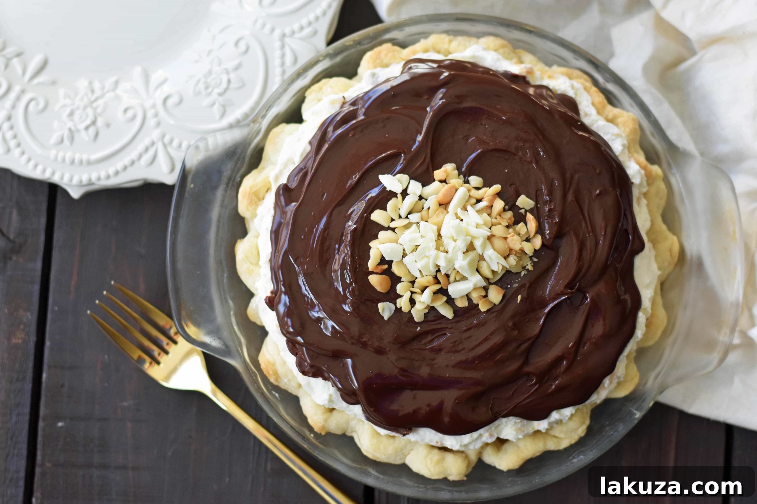 White Chocolate Macadamia Pie made with a fluffy white chocolate cream filling studded with orange zest and macadamia nuts and topped with a silky smooth chocolate ganache and freshly whipped cream. White Chocolate Orange Chocolate Ganache Pie. The BEST PIE ever! www.modernhoney.com