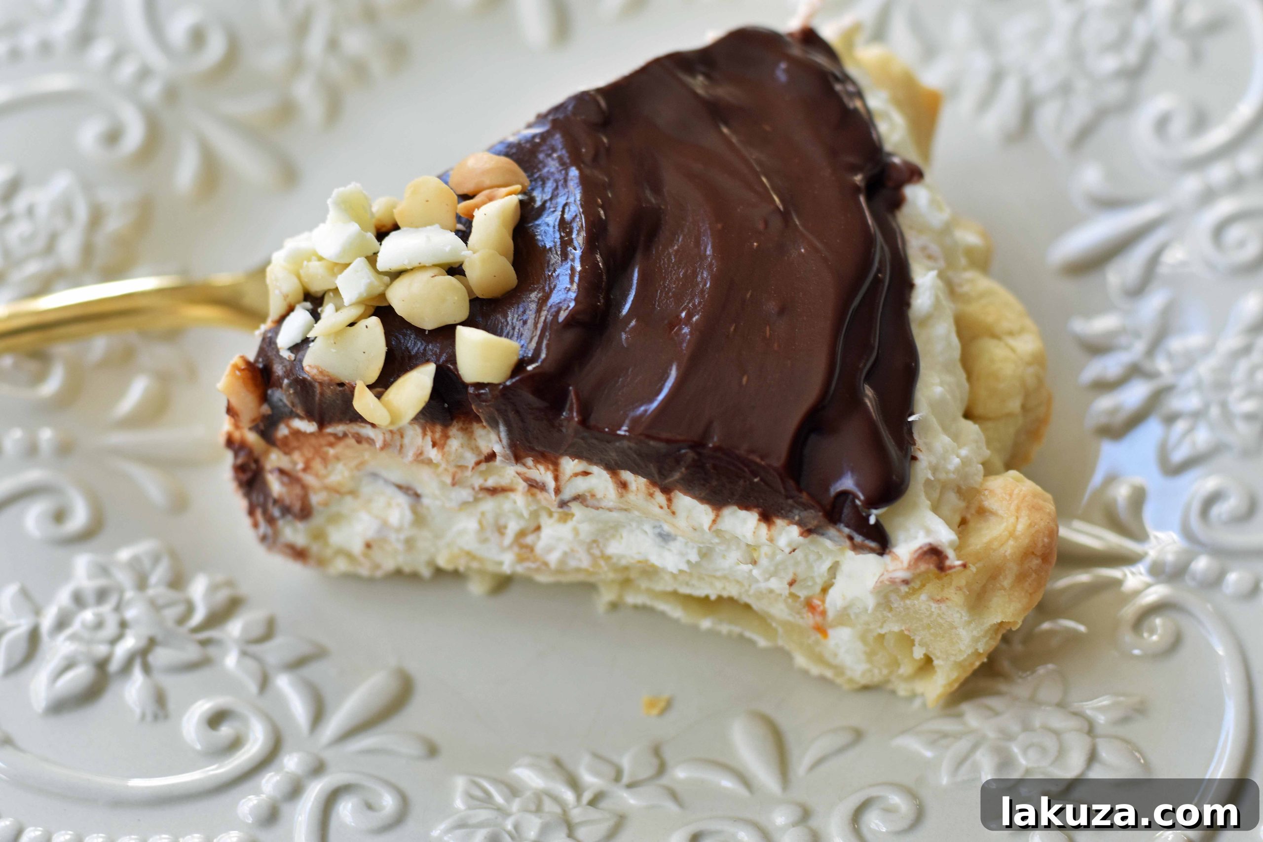 White Chocolate Macadamia Pie made with a fluffy white chocolate cream filling studded with orange zest and macadamia nuts and topped with a silky smooth chocolate ganache and freshly whipped cream. White Chocolate Orange Chocolate Ganache Pie. The BEST PIE ever! www.modernhoney.com