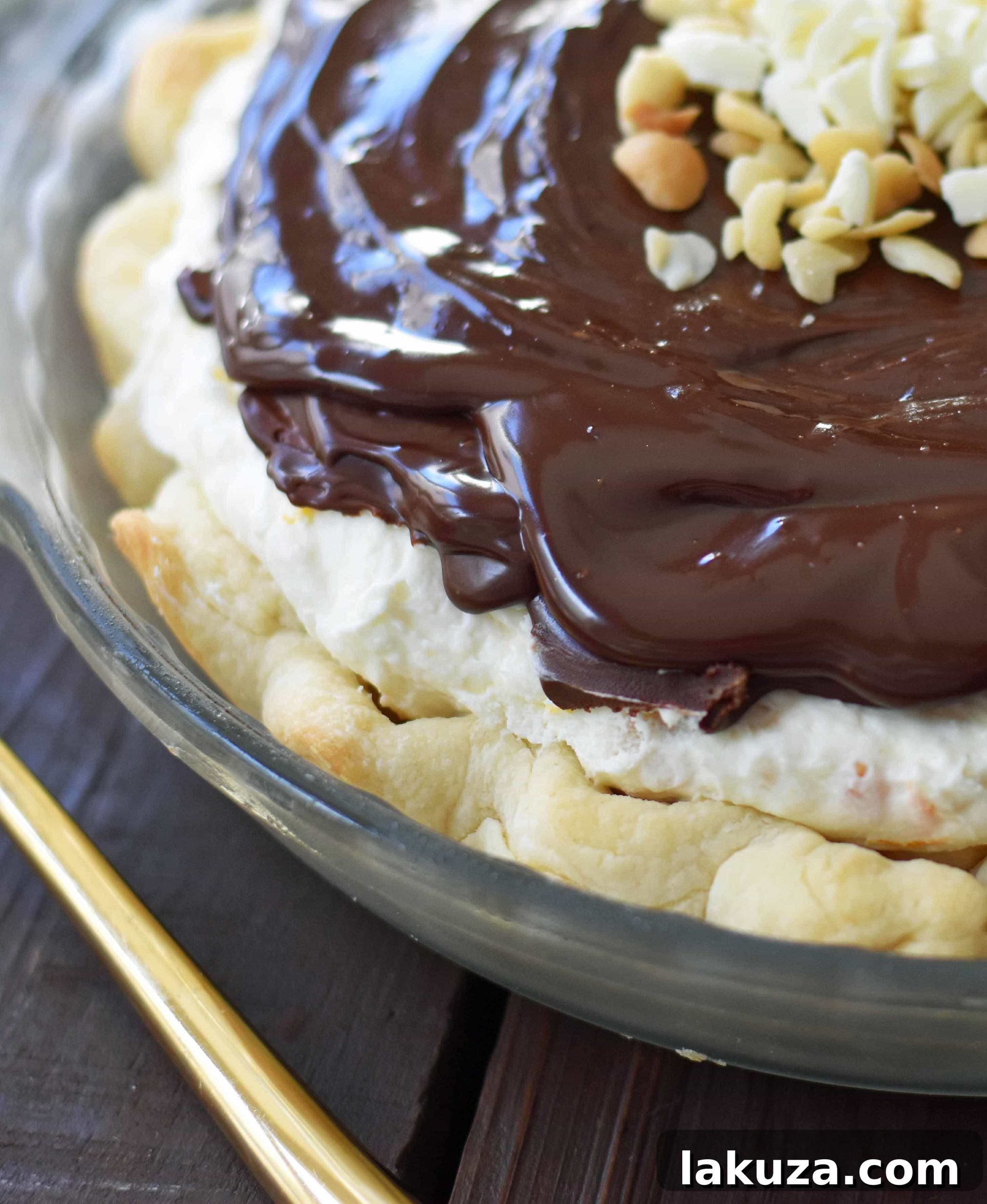 White Chocolate Macadamia Pie made with a fluffy white chocolate cream filling studded with orange zest and macadamia nuts and topped with a silky smooth chocolate ganache and freshly whipped cream. White Chocolate Orange Chocolate Ganache Pie. The BEST PIE ever! www.modernhoney.com
