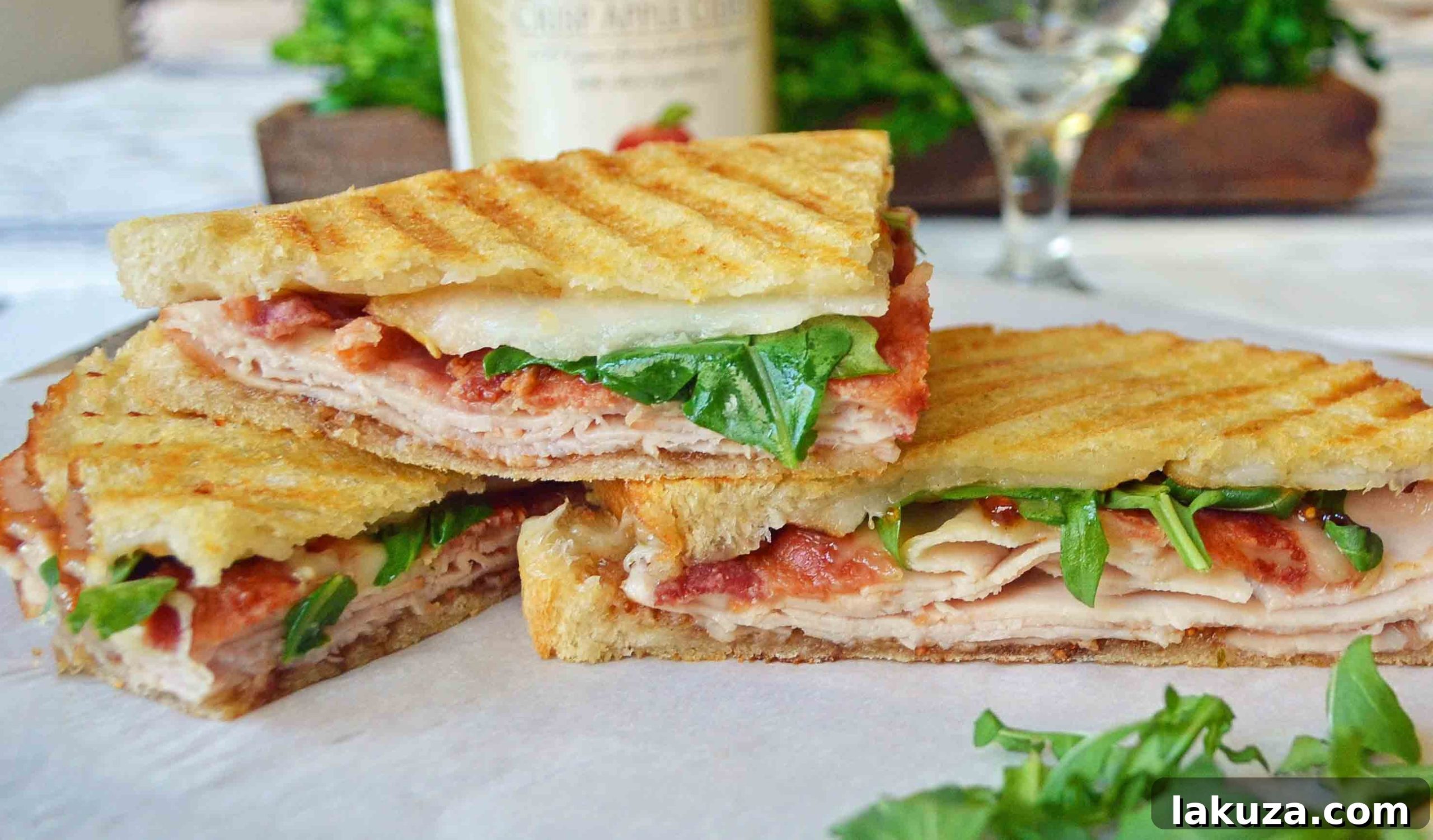 Delicious Turkey Bacon Panini with Havarti cheese, fig spread, and fresh arugula on toasted bread