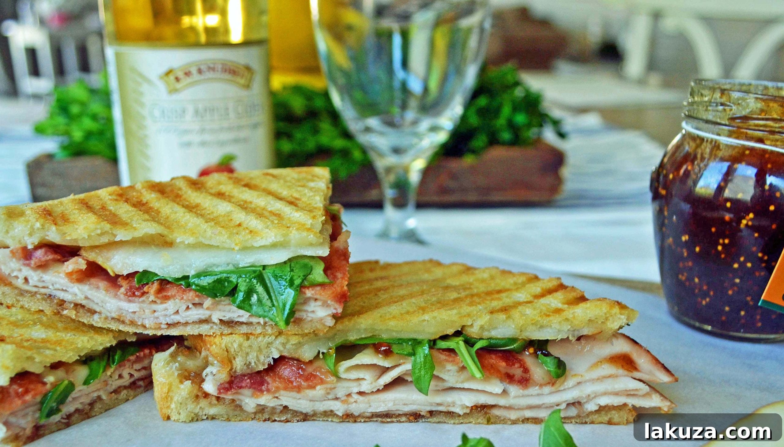 Close-up of a gourmet Turkey Bacon Panini with melted cheese and fresh ingredients