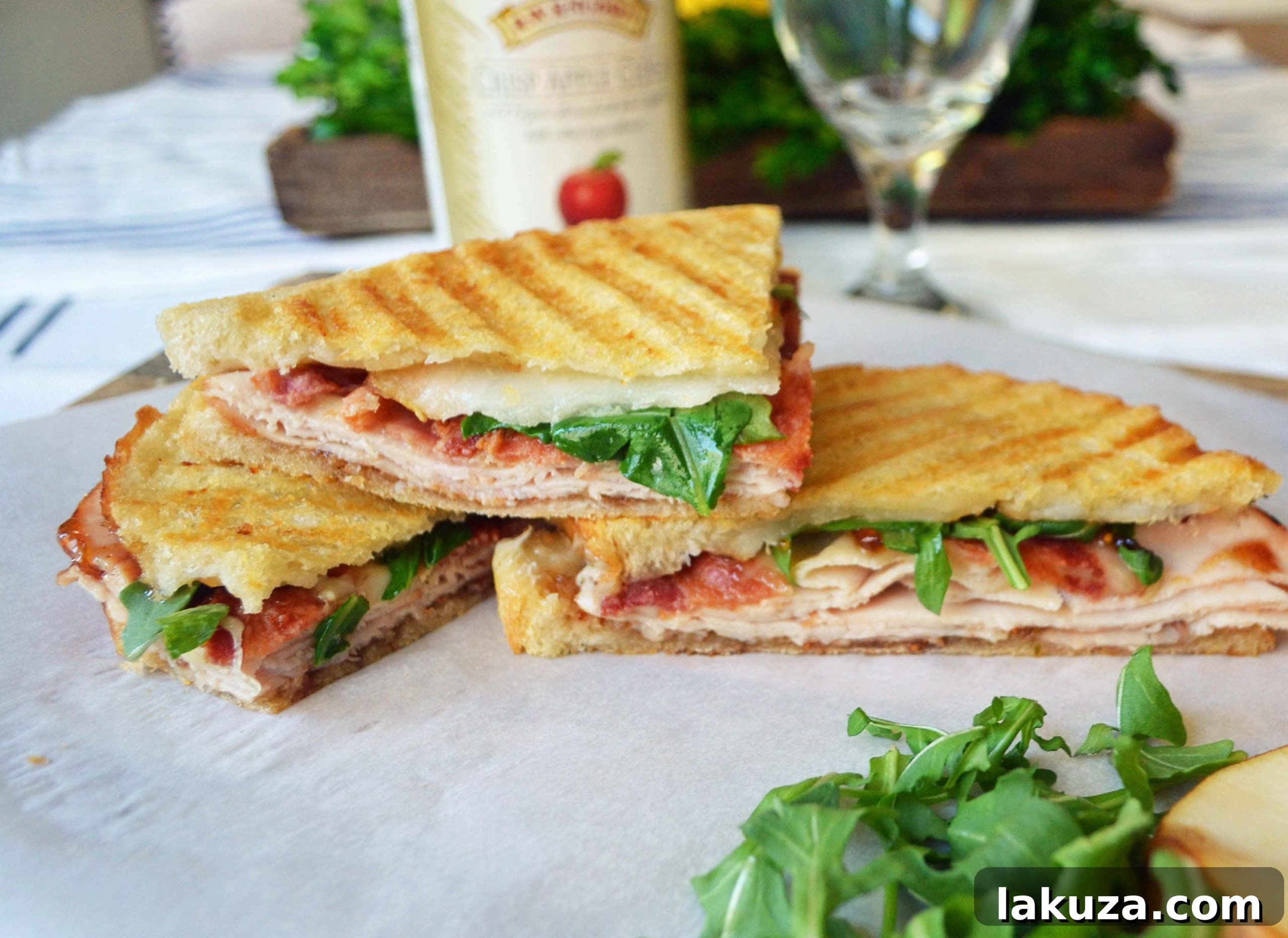Two halves of a perfectly toasted Turkey Bacon Panini, revealing its layers