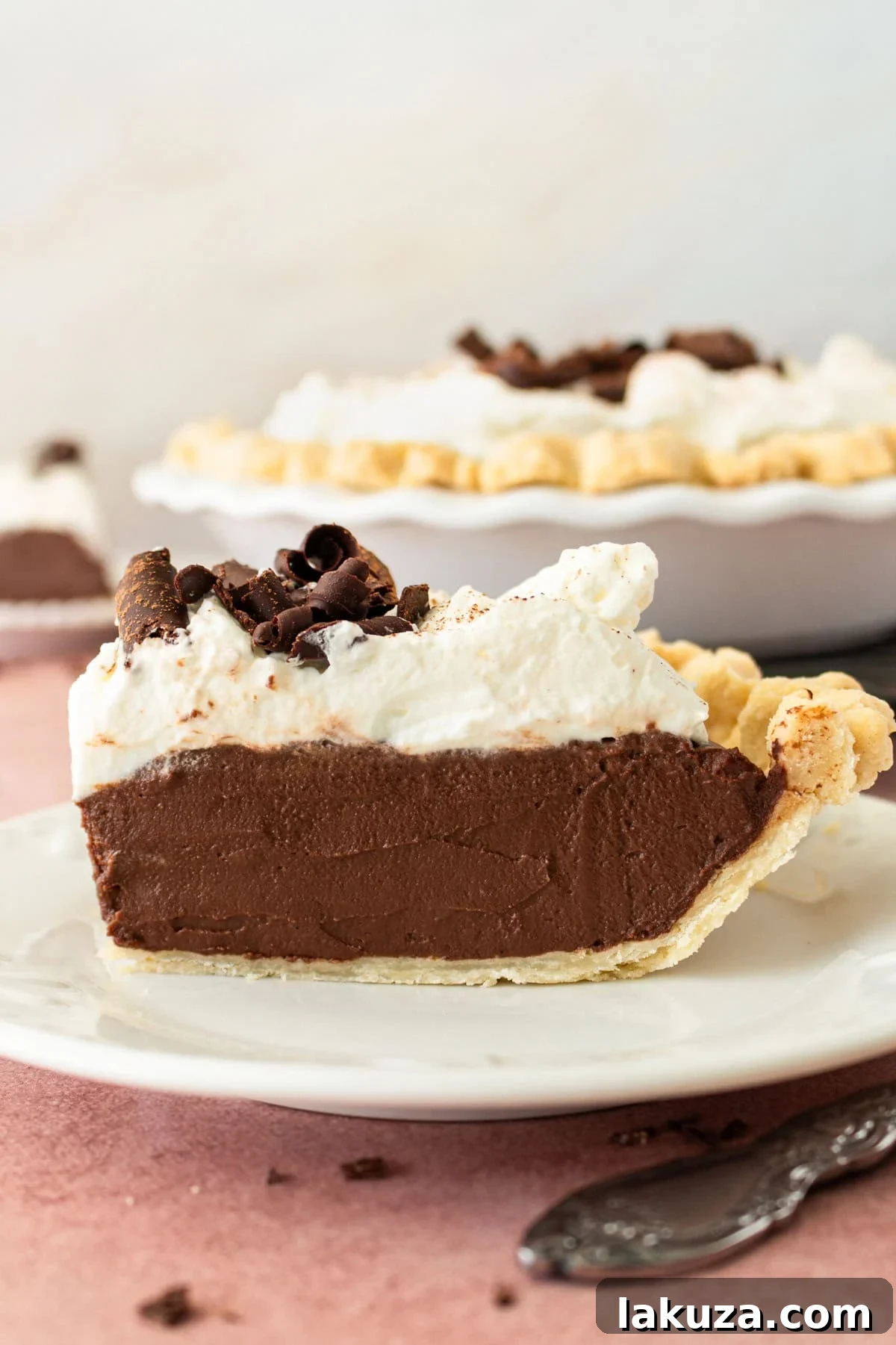 Decadent Chocolate Cream Pie with homemade whipped cream and chocolate shavings.