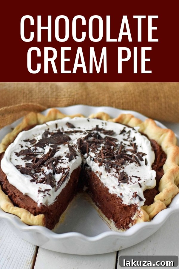 Close-up of a full Chocolate Cream Pie, focusing on the texture of the whipped cream and chocolate shavings.